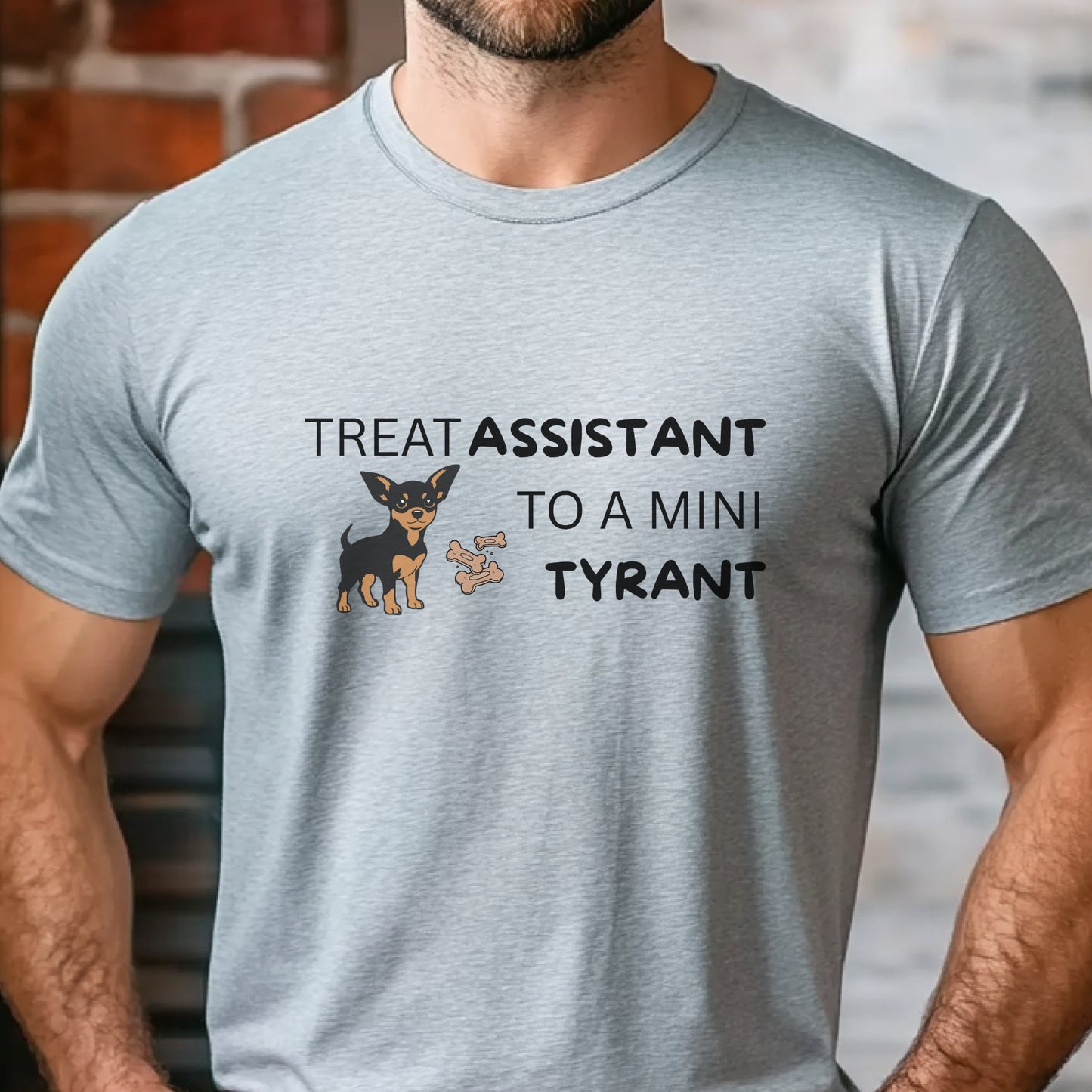 Grey unisex t-shirt with Miniature Pinscher illustration and text: "Treat Assistant to a Mini Tyrant"
