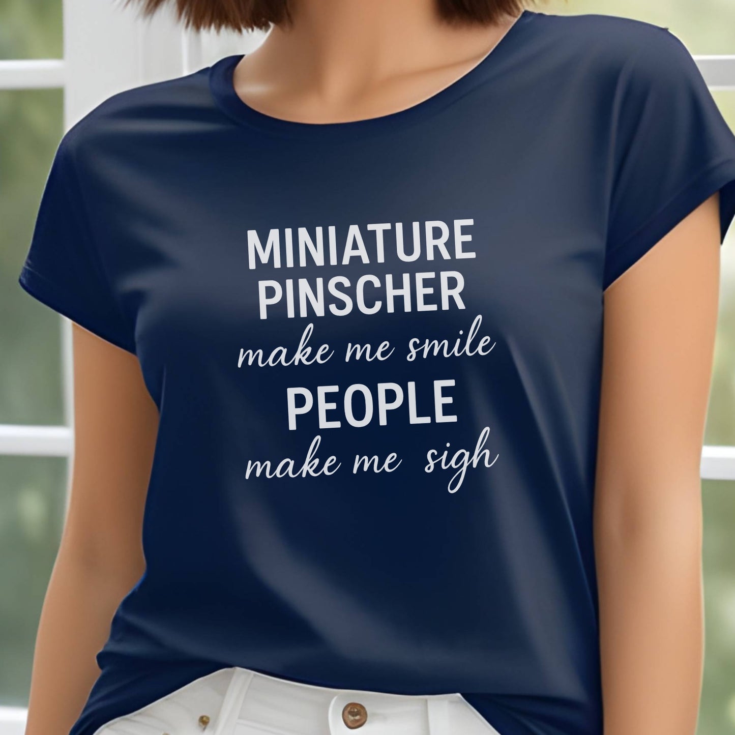Woman wearing a navy"Miniature Pinscher make me smile, people make me sigh" unisex t-shirt, casual background