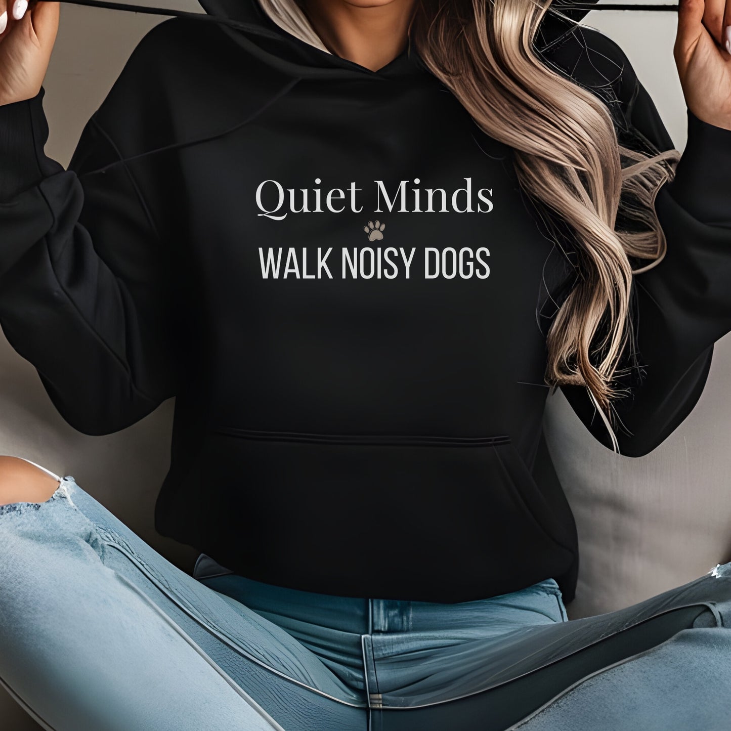 Woman wearing black hoodie with “Quiet Minds Walk Noisy Dogs” text, perfect for dog lovers and walkers