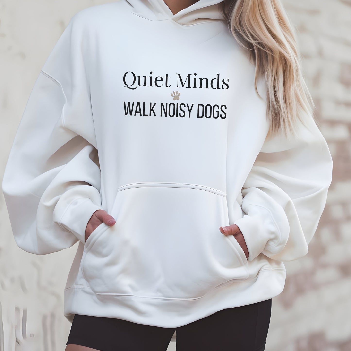 White hoodie with text 'Quiet Minds Walk Noisy Dogs' worn by a person.