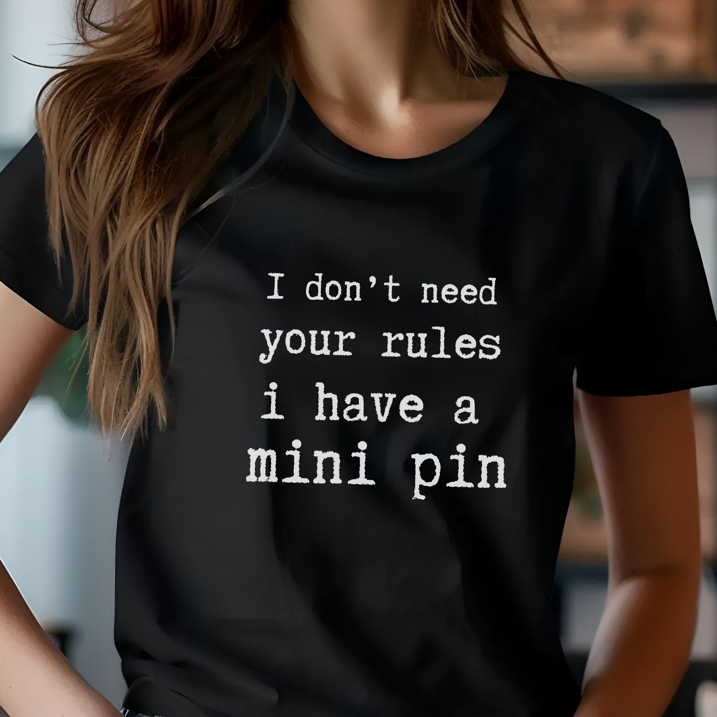 Black unisex t-shirt with white text: "I don’t need your rules, I have a mini pin" centered on the chest
