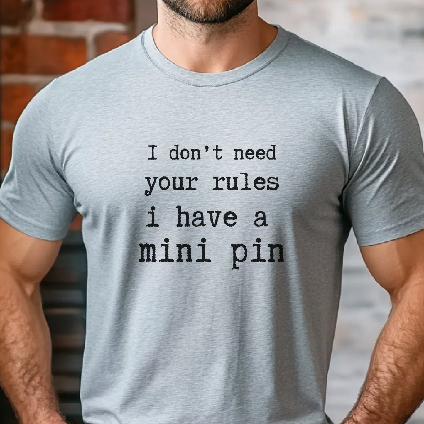 Grey unisex t-shirt with white text: "I don’t need your rules, I have a mini pin" centered on the chest