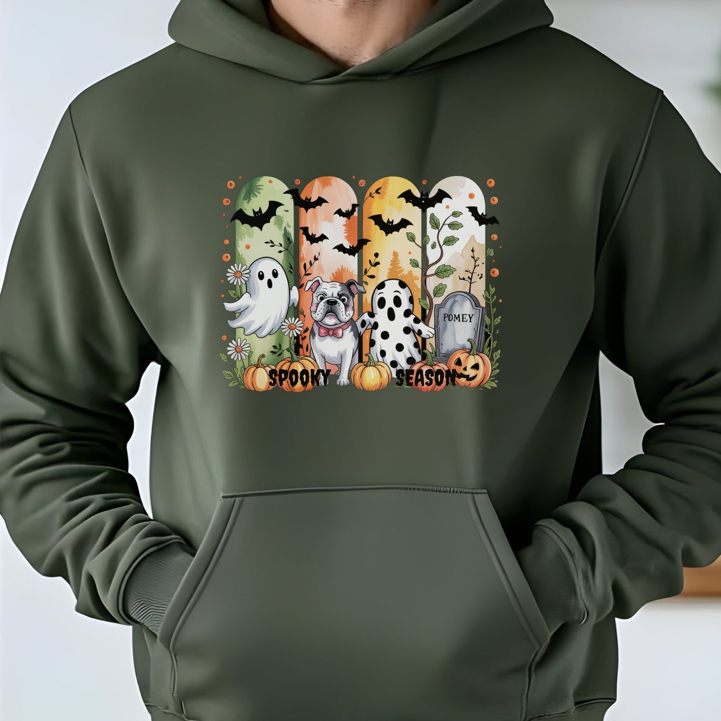 Military green hoodie with Halloween-themed print of small dogs in ghost costumes, bats, pumpkins, and “Spooky Season” text on the front.