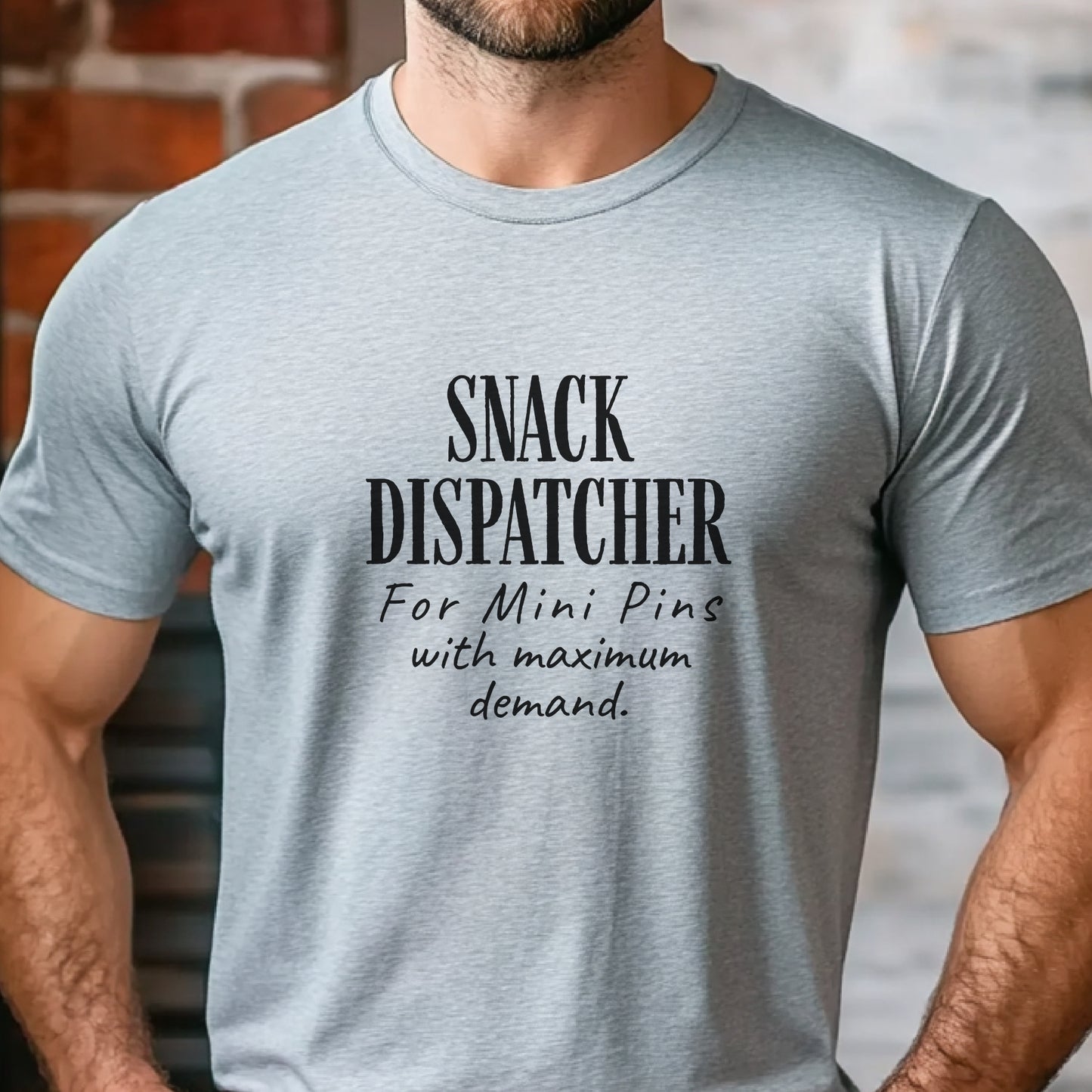 Man wearing a grey t-shirt with black text: "SNACK DISPATCHER – For Mini Pins with maximum demand