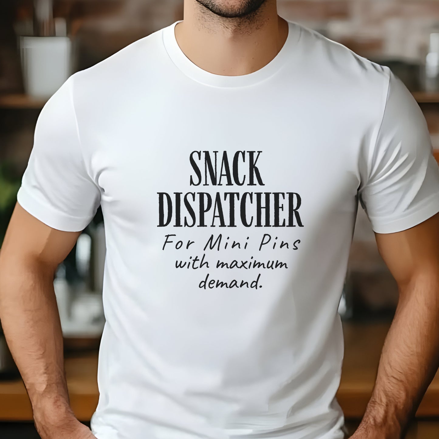 Man wearing a white t-shirt with black text: "SNACK DISPATCHER – For Mini Pins with maximum demand