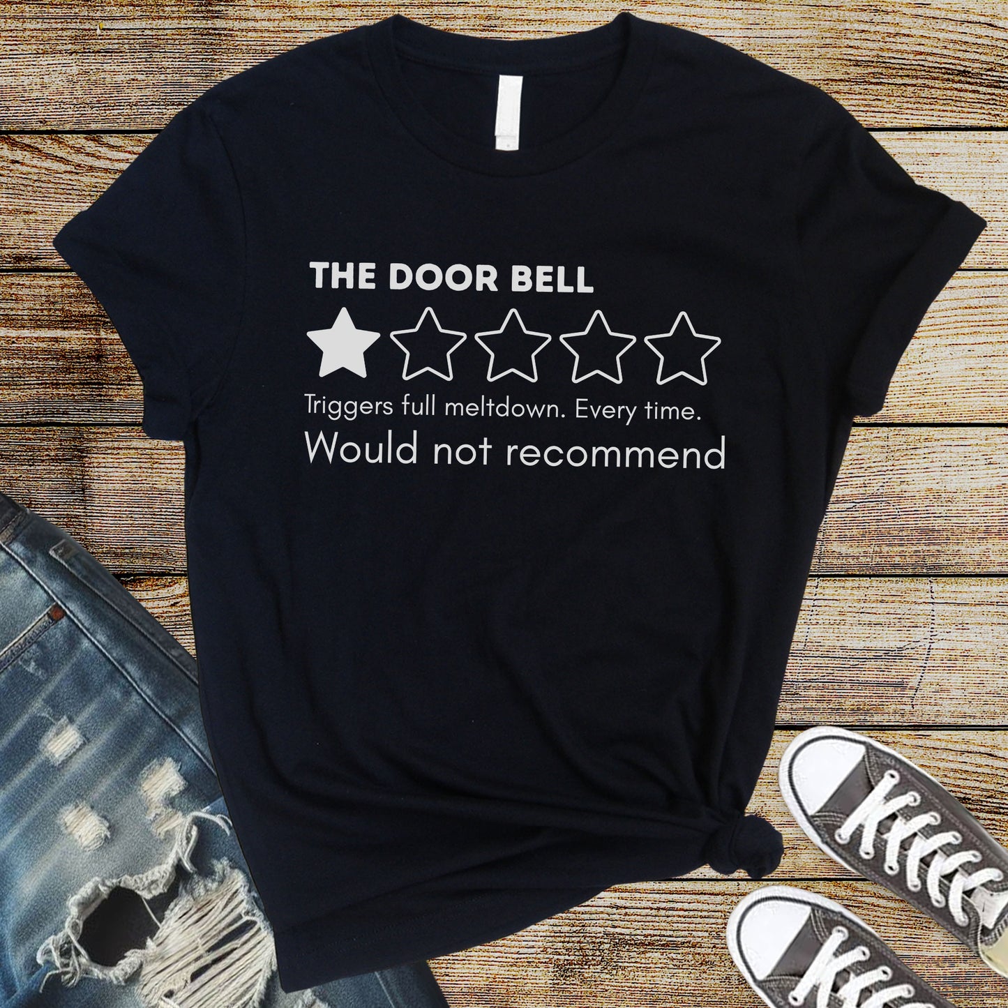Black flat lay t-shirt with “The Door Bell” text, 1-star review graphic, and “Would not recommend” meltdown humor design