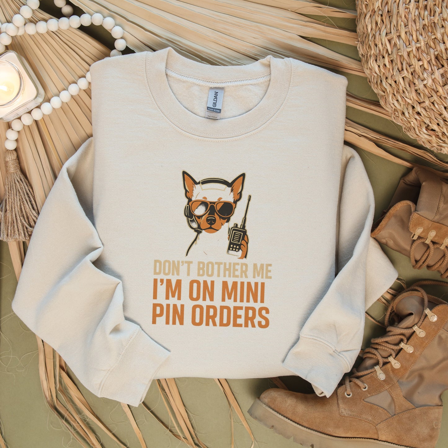 Beige unisex sweatshirt flat lay with a Miniature Pinscher in headset and sunglasses, text: "DON’T BOTHER ME I’M ON MINI PIN ORDERS"