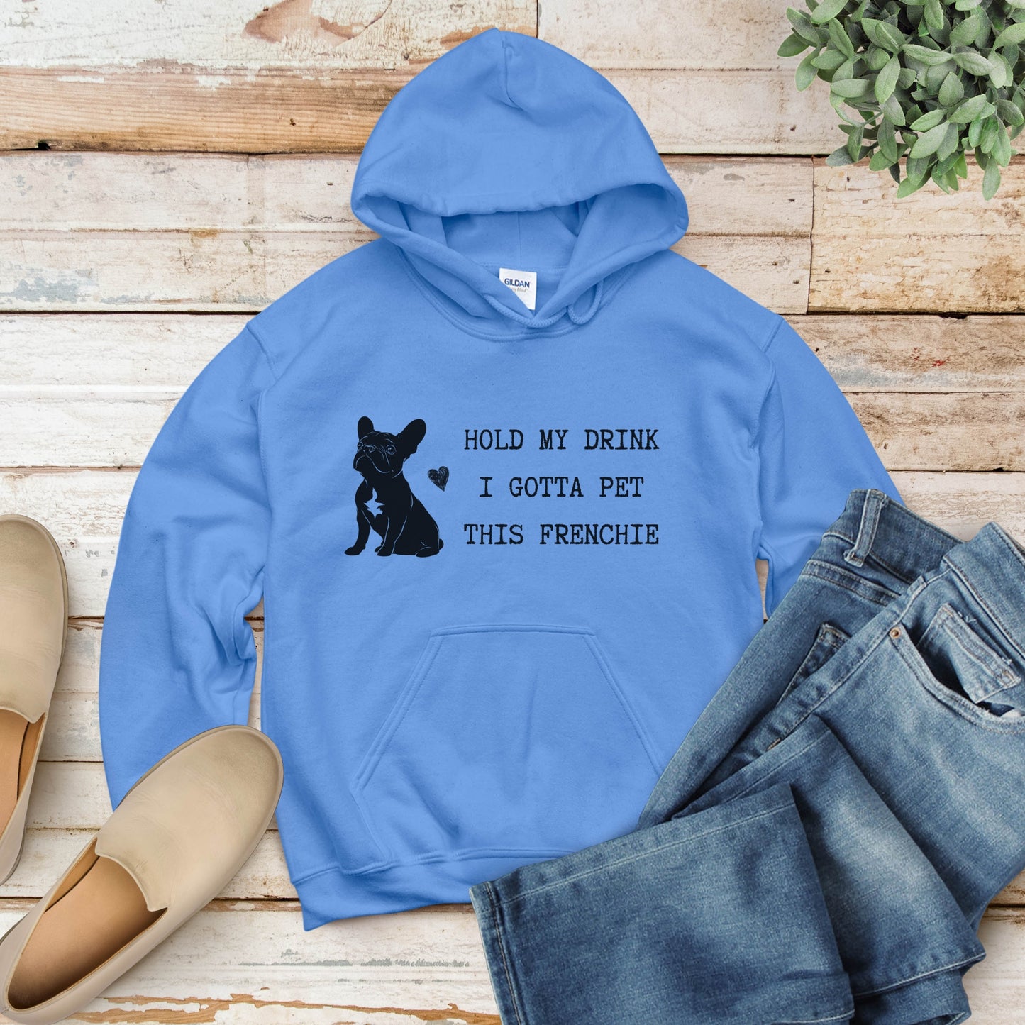 California blue flat lay hoodie with a black line-art French Bulldog illustration and the bold text “Hold my drink, I gotta pet this Frenchie” printed on the front.