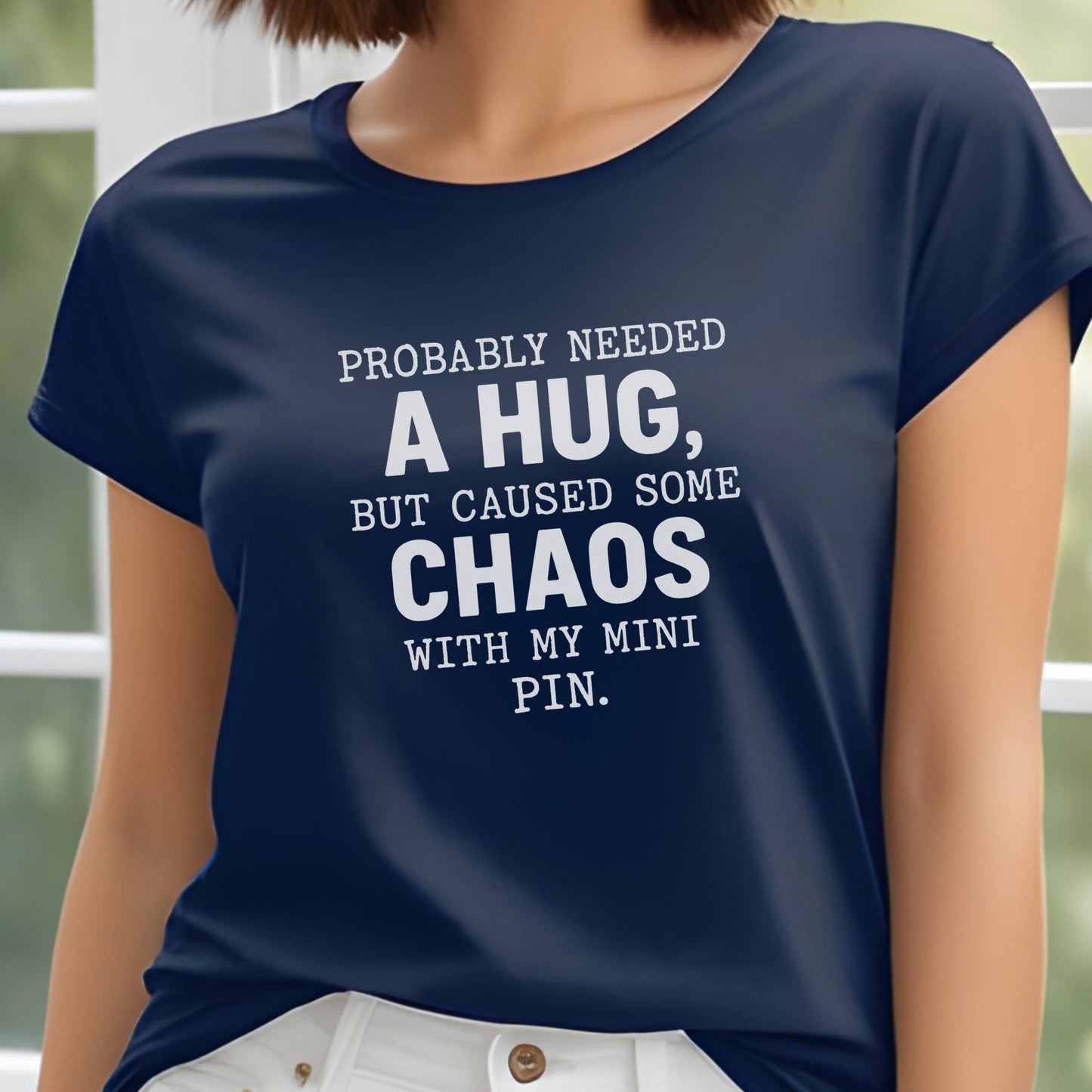 Navy unisex t-shirt with white text: "Probably needed a hug, but caused some chaos with my Mini Pin." centered on the chest