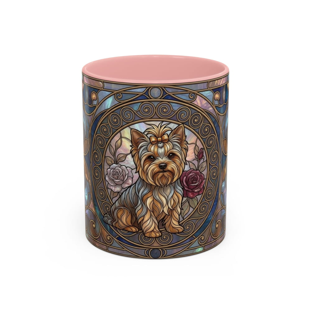 A cylindrical ceramic mug featuring a decorative Art Nouveau-style illustration of a Yorkshire Terrier dog with roses, surrounded by ornate blue and gold filigree patterns. The mug has a solid pink interior and is photographed on a clean white background.