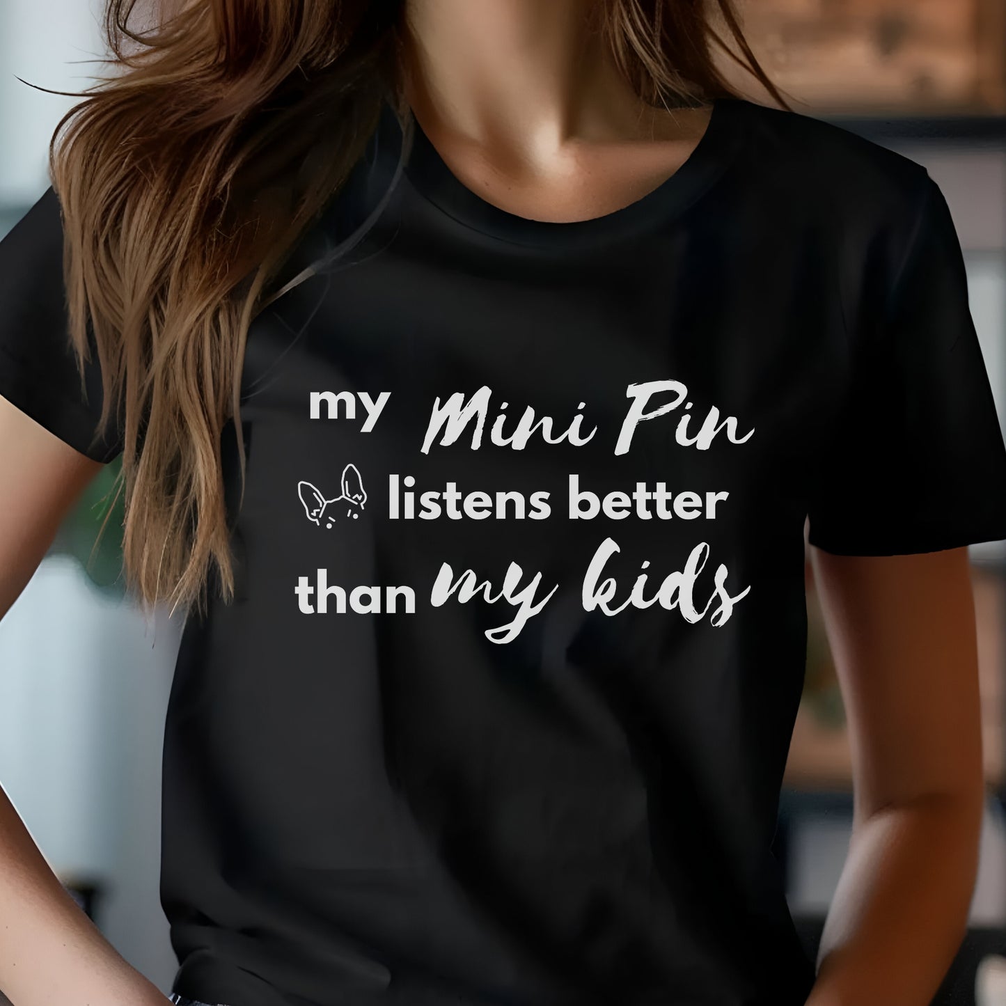 Black unisex t-shirt with white text: "my Mini Pin listens better than my kids" and a small Miniature Pinscher face illustration