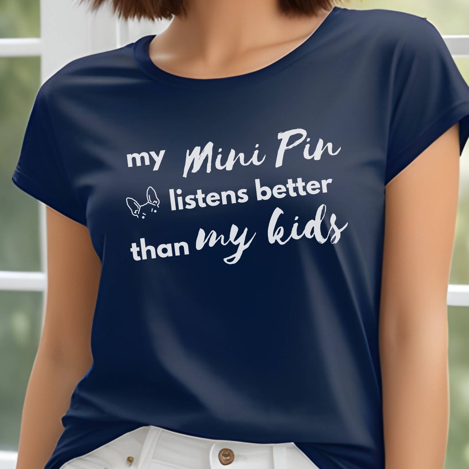 Navy unisex t-shirt with white text: "my Mini Pin listens better than my kids" and a small Miniature Pinscher face illustration