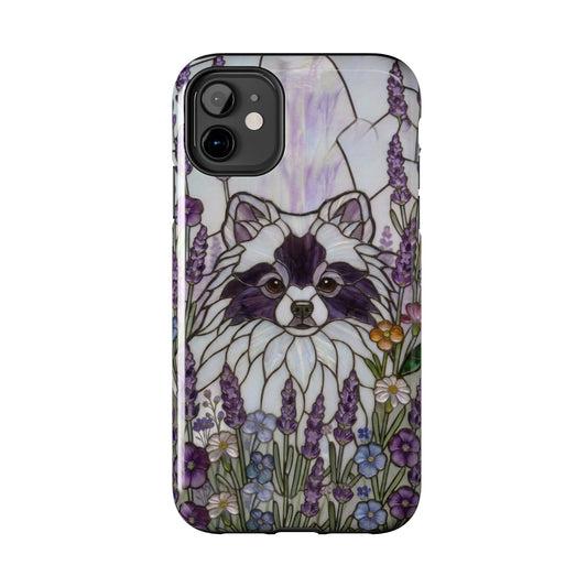 Phone case with a raccoon illustration surrounded by flowers on a white background