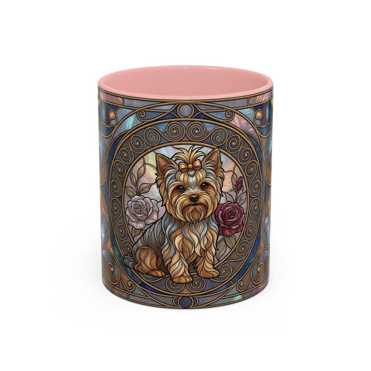 A cylindrical ceramic mug featuring a decorative Art Nouveau-style illustration of a Yorkshire Terrier dog with roses, surrounded by ornate blue and gold filigree patterns. The mug has a solid pink interior and is photographed on a clean white background.