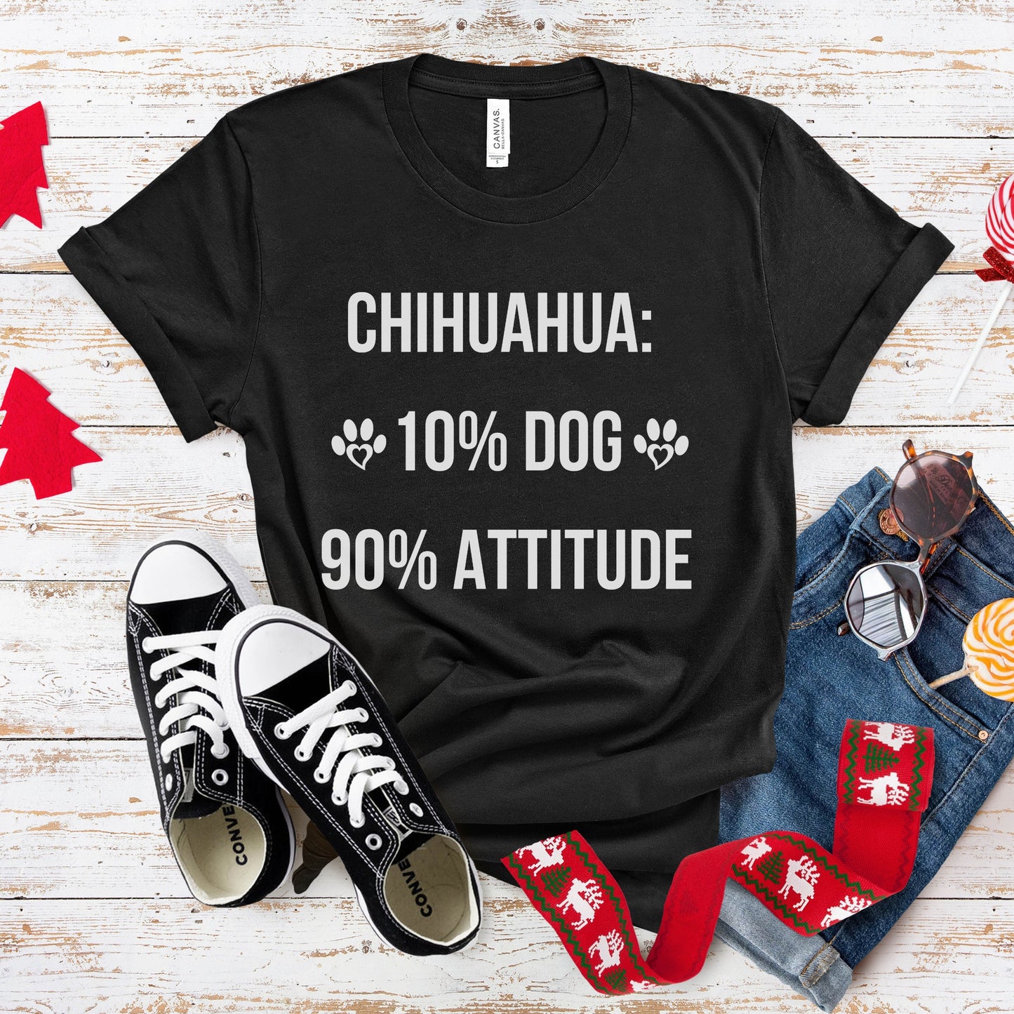 Black t-shirt with 'CHIHUAHUA: 10% DOG 90% ATTITUDE' text on a wooden surface with shoes and socks.