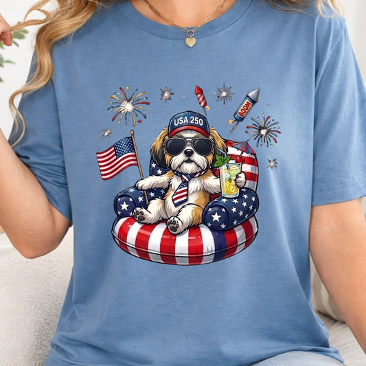 Blue t-shirt with a dog graphic featuring American flags and fireworks.