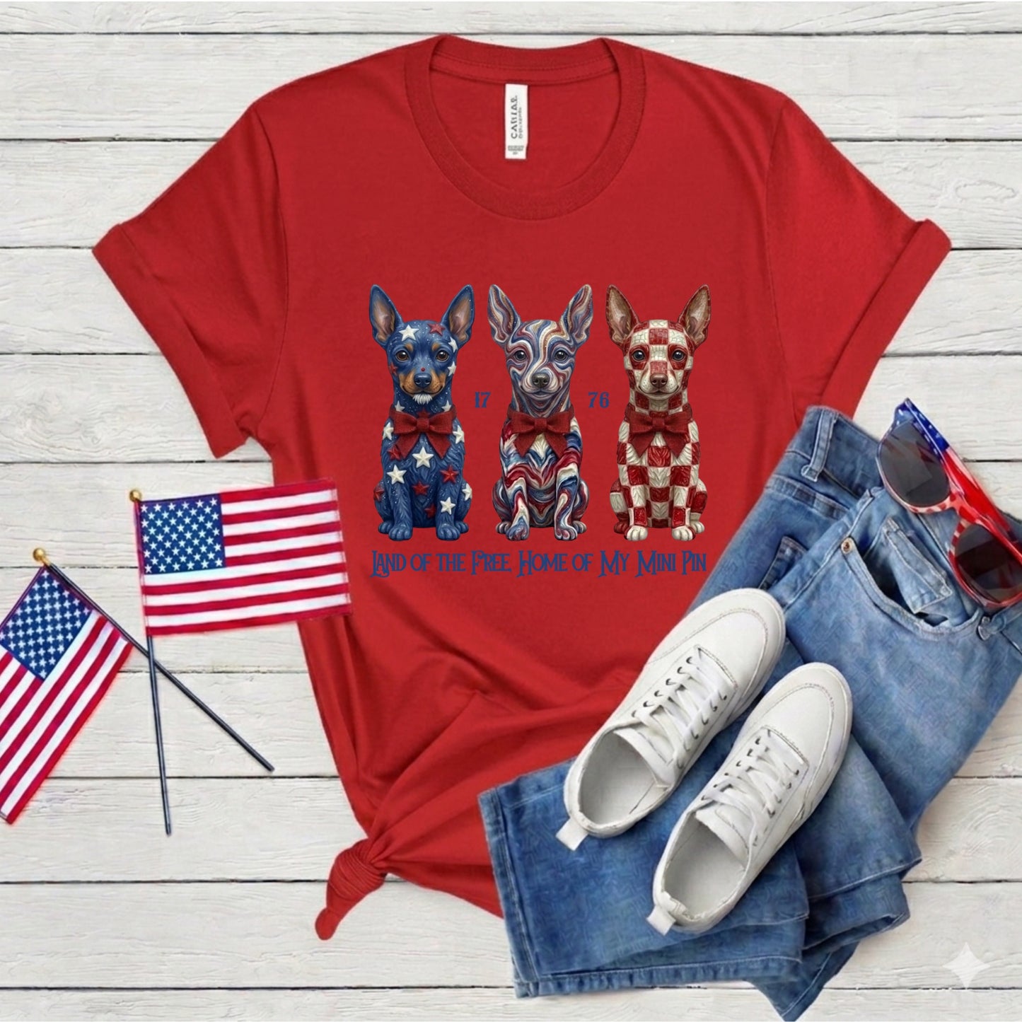Red t-shirt with dog graphic and American flags on a wooden surface