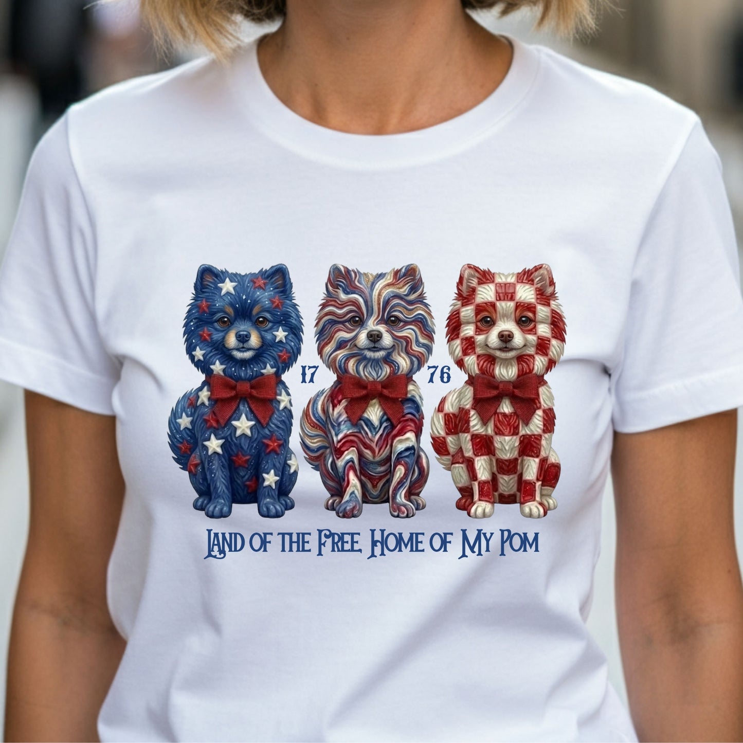 White t-shirt with patriotic dog illustrations and text worn by a person.