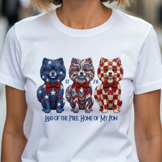 White t-shirt with patriotic dog illustrations and text worn by a person.