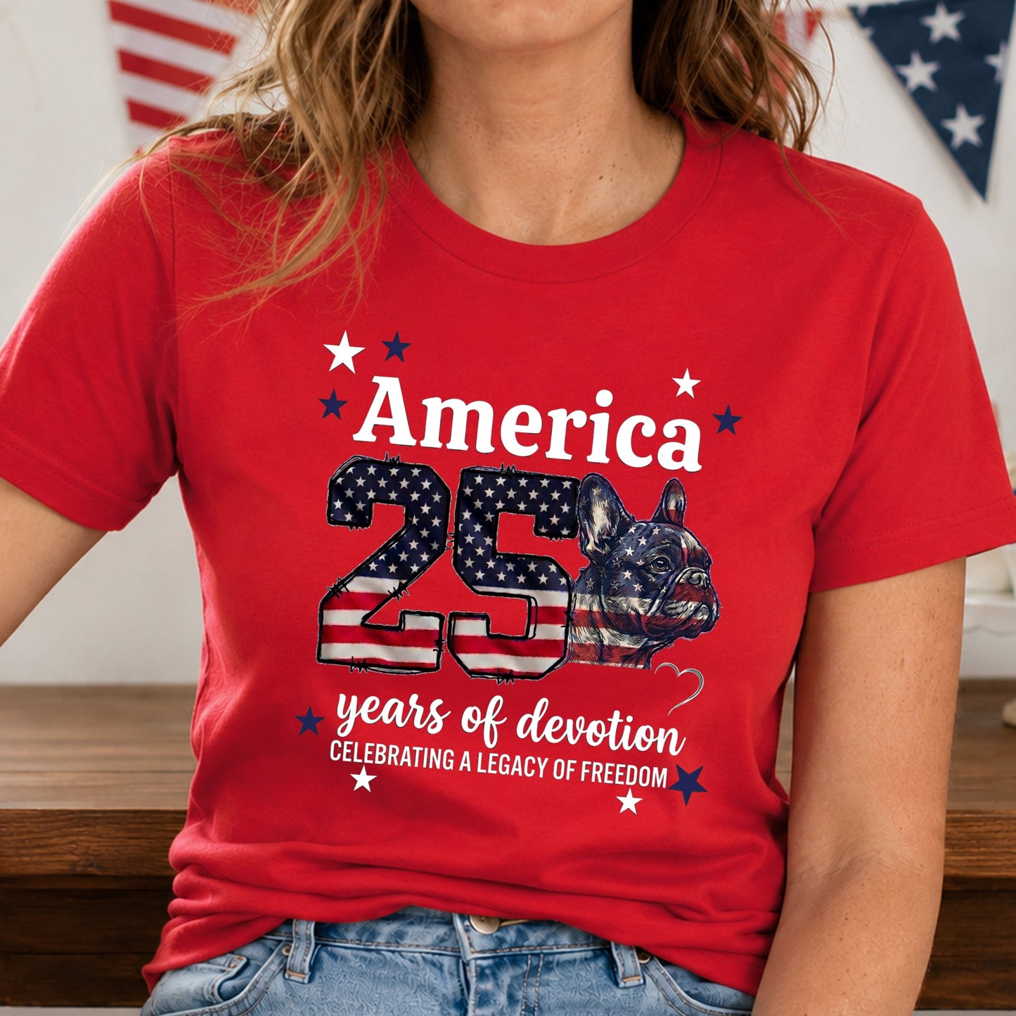 Person wearing a red t-shirt with 'America 25 years of devotion' design.