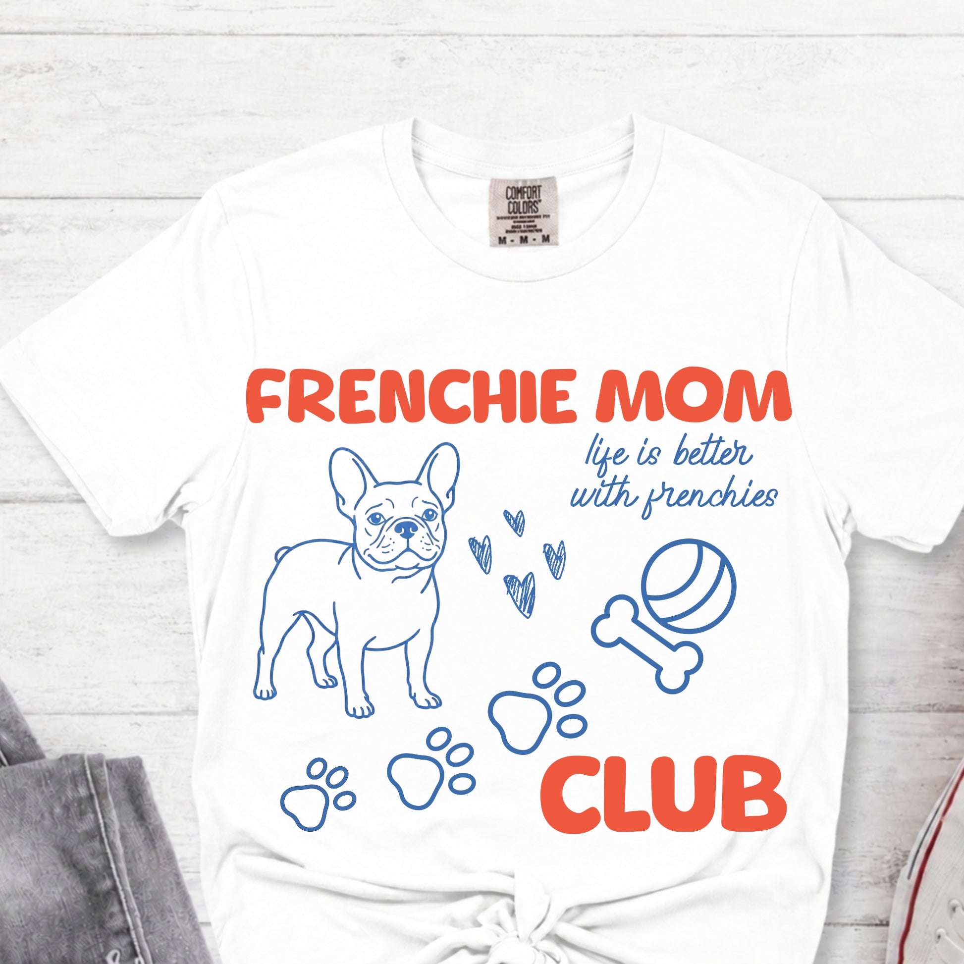 White t-shirt with 'Frenchie Mom Club' design featuring a French Bulldog illustration on a white background.