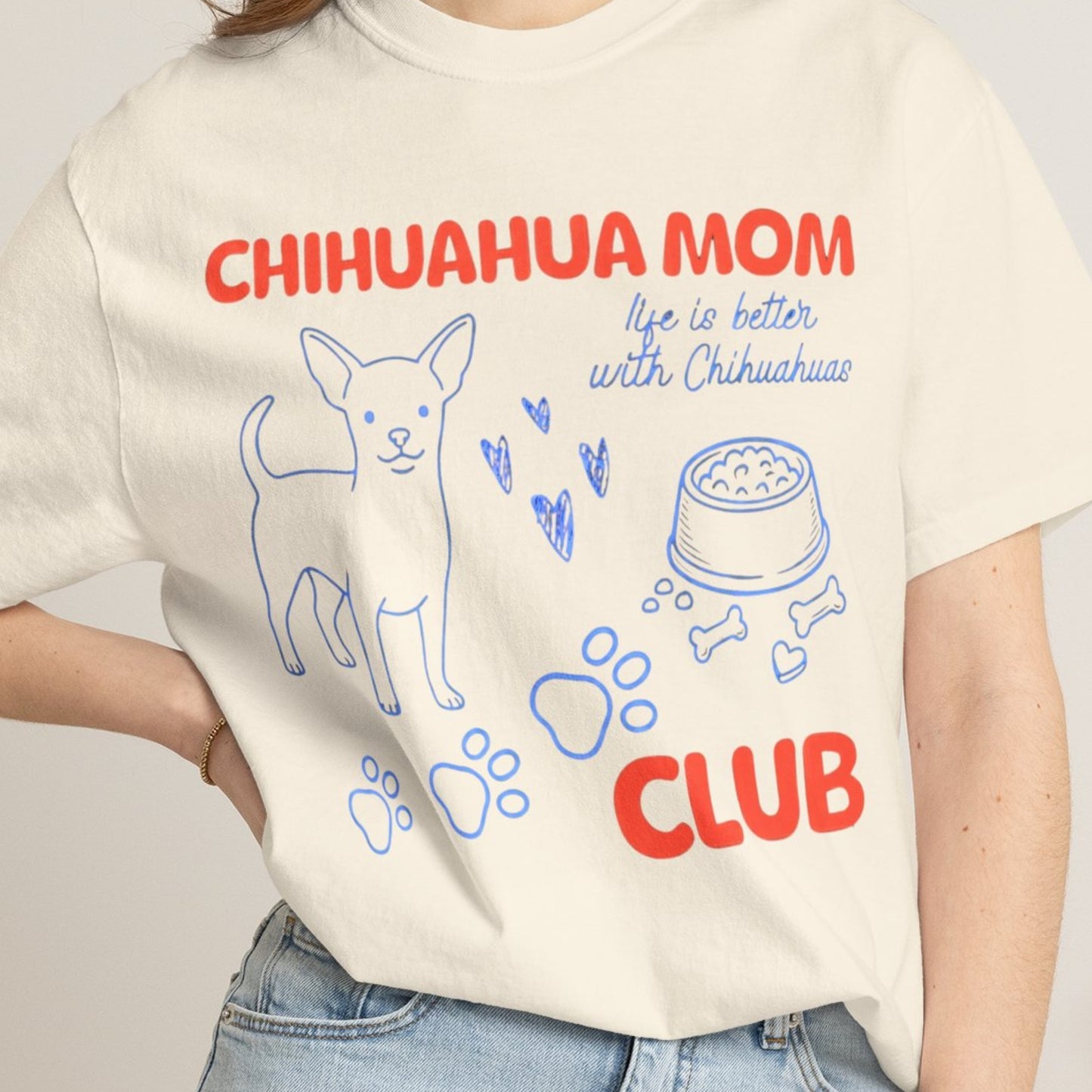 Person wearing a t-shirt with 'Chihuahua Mom Club' text and graphics.