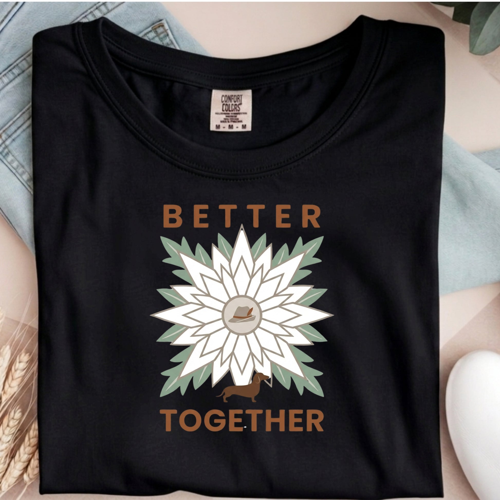 Black t-shirt with a floral design and 'Better Together' text on a neutral background