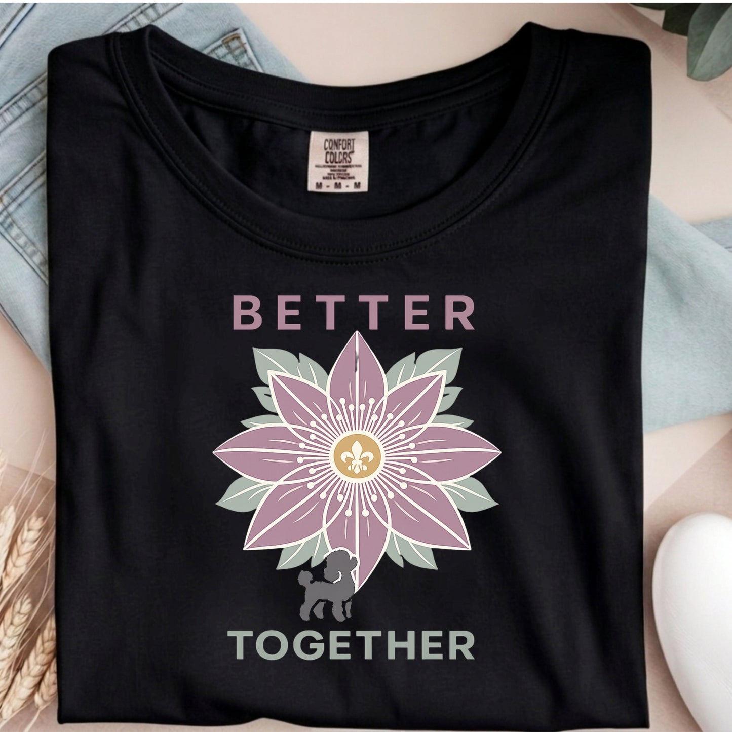 Black t-shirt with a flower design and 'Better Together' text on a neutral background