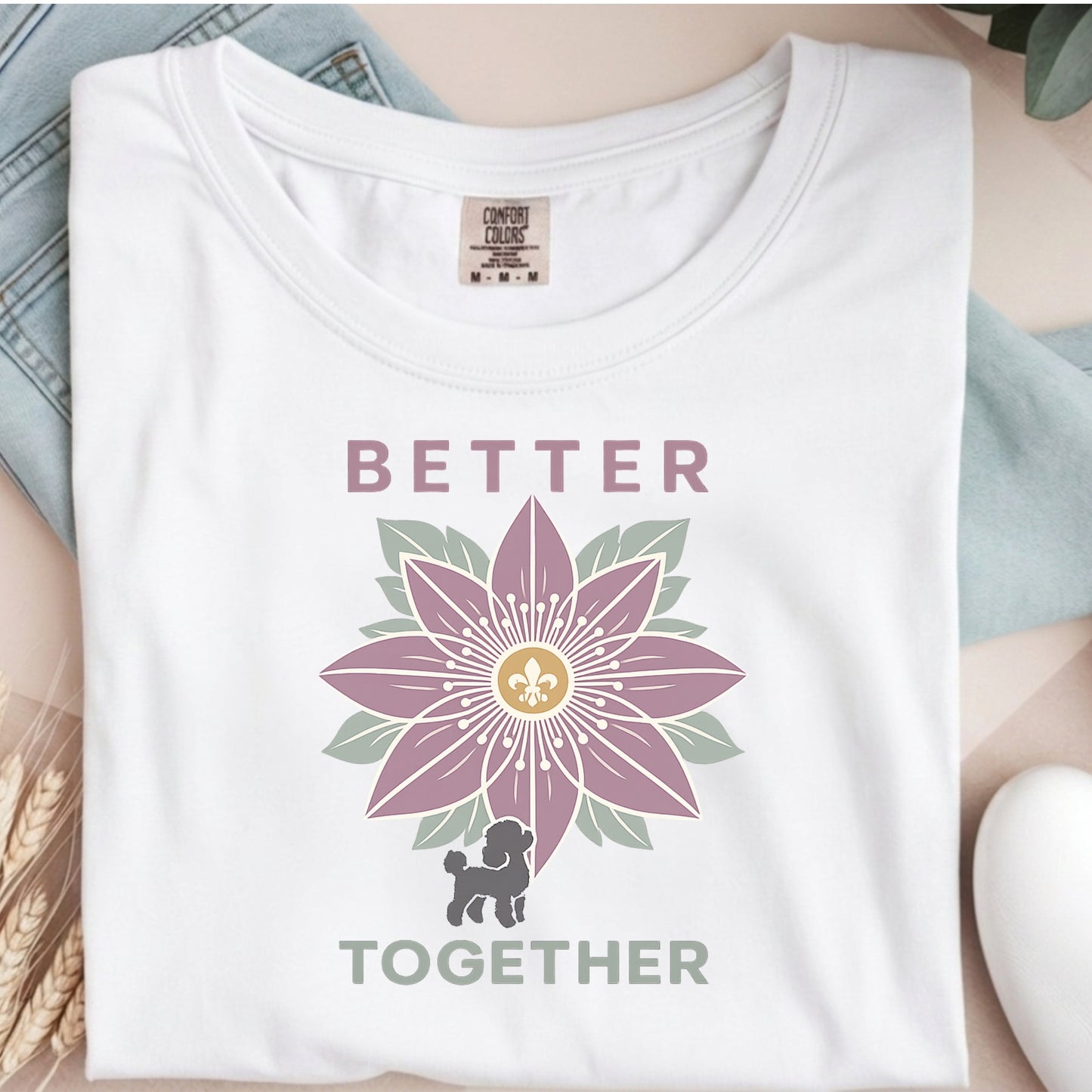 White t-shirt with a purple flower design and text 'Better Together' on a neutral background