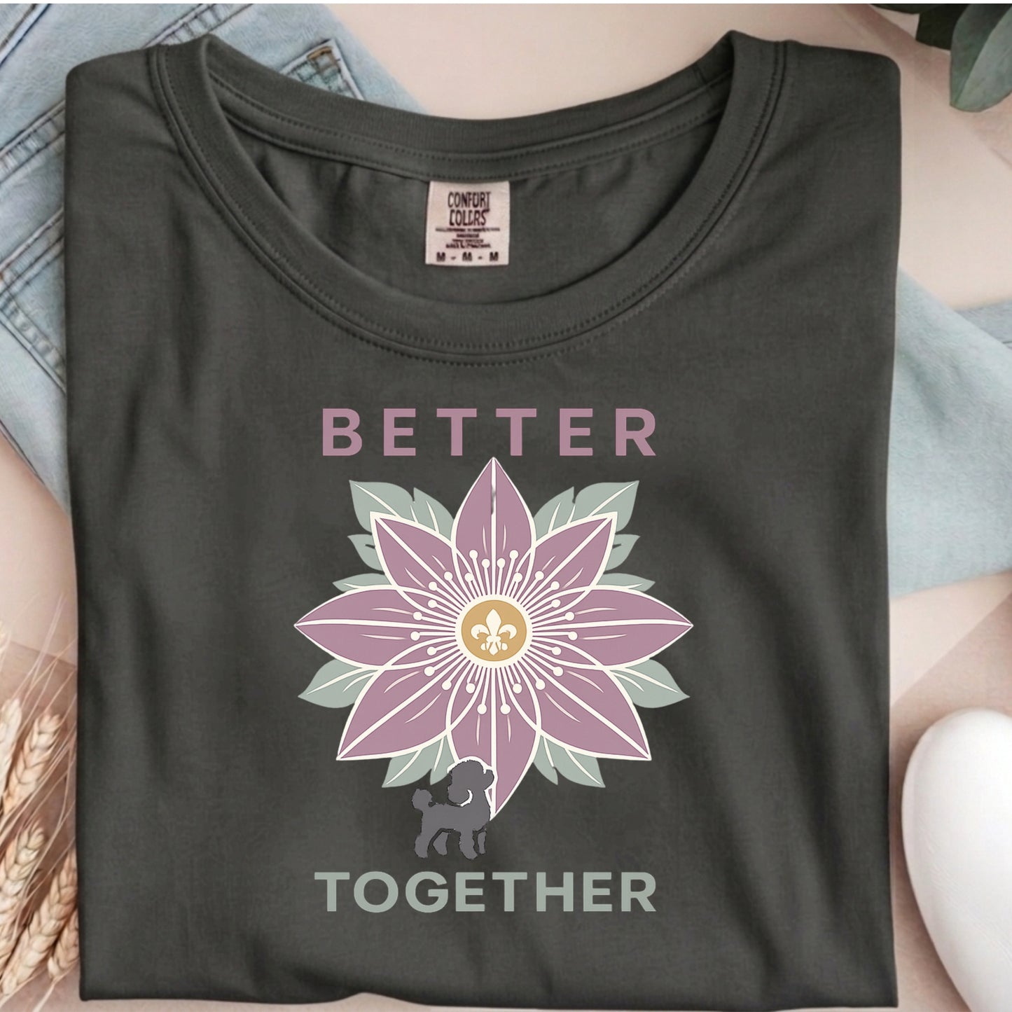 Dark gray t-shirt with a flower design and 'Better Together' text on a textured surface.
