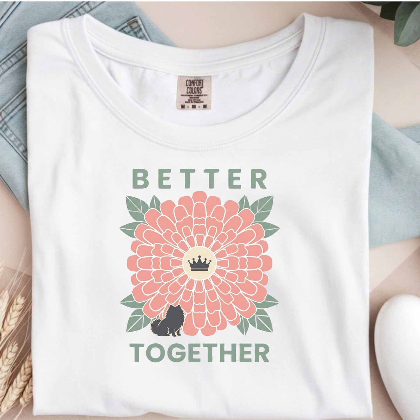 White t-shirt with a floral design and 'Better Together' text on a neutral background