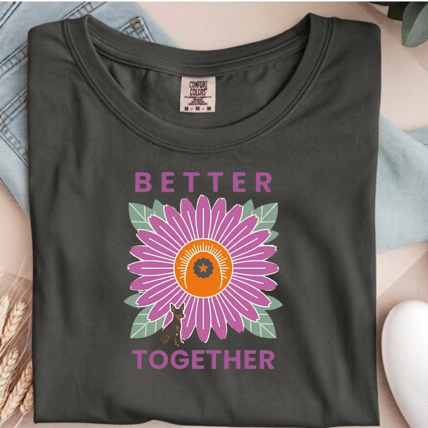Dark gray t-shirt with a purple flower graphic and 'Better Together' text on a neutral background.