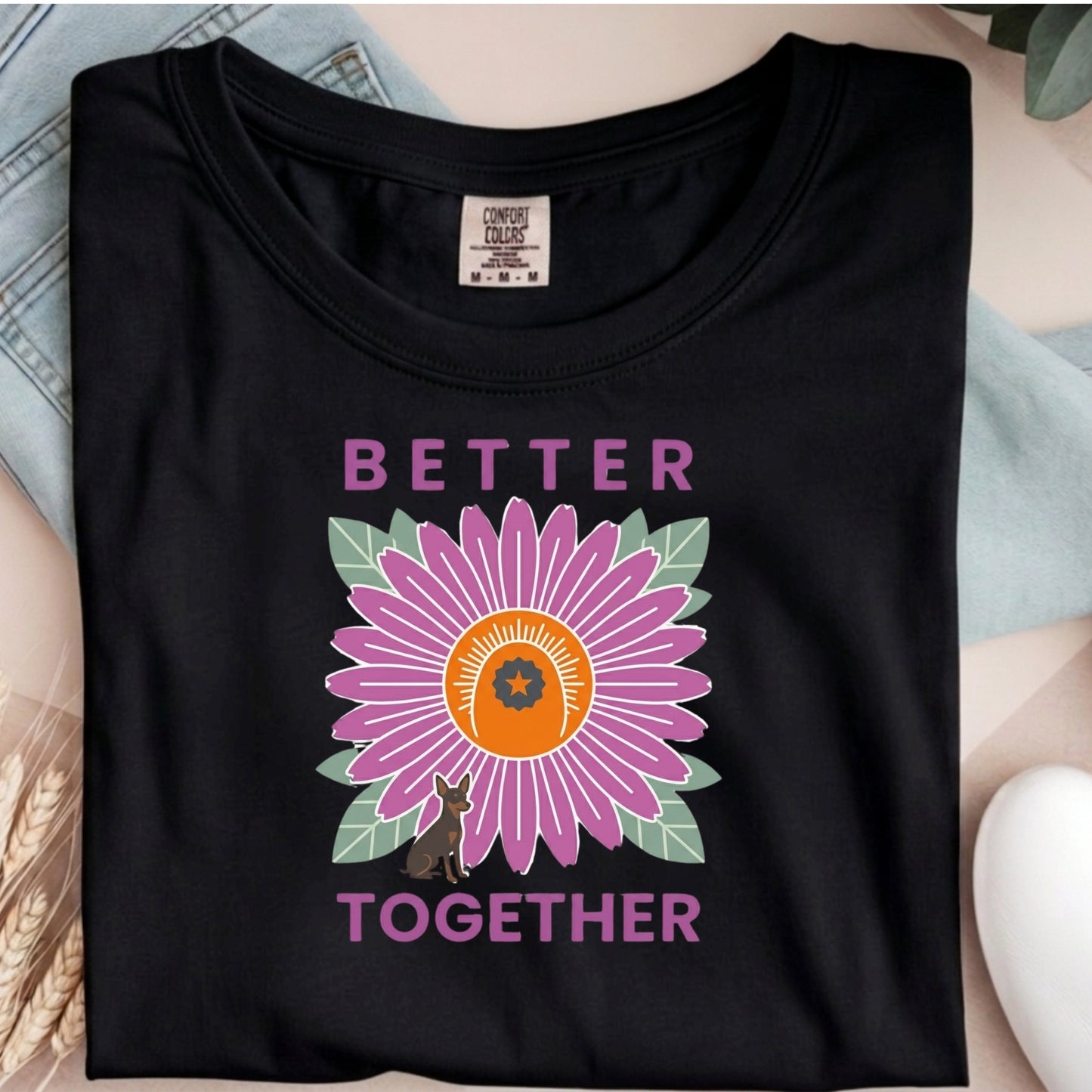 Black t-shirt with a purple flower graphic and 'Better Together' text on a neutral background