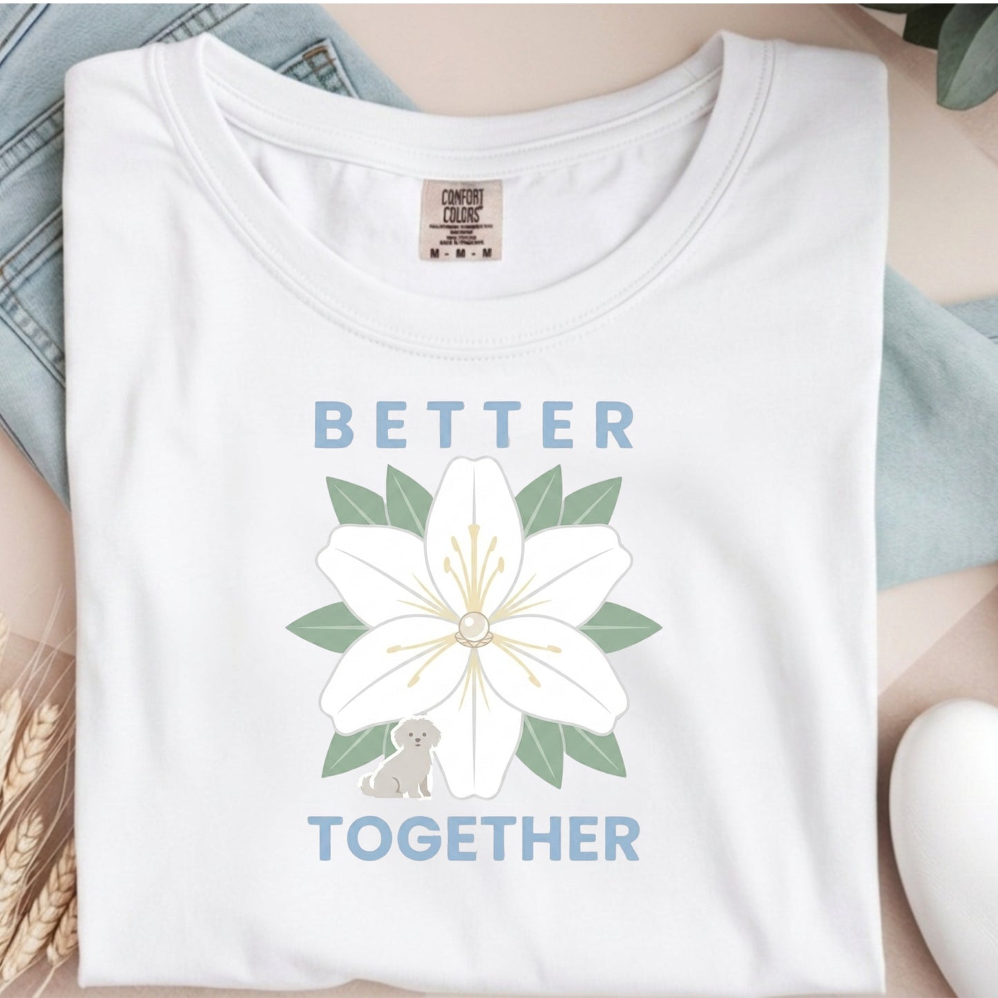 White t-shirt with a flower design and 'Better Together' text on a neutral background