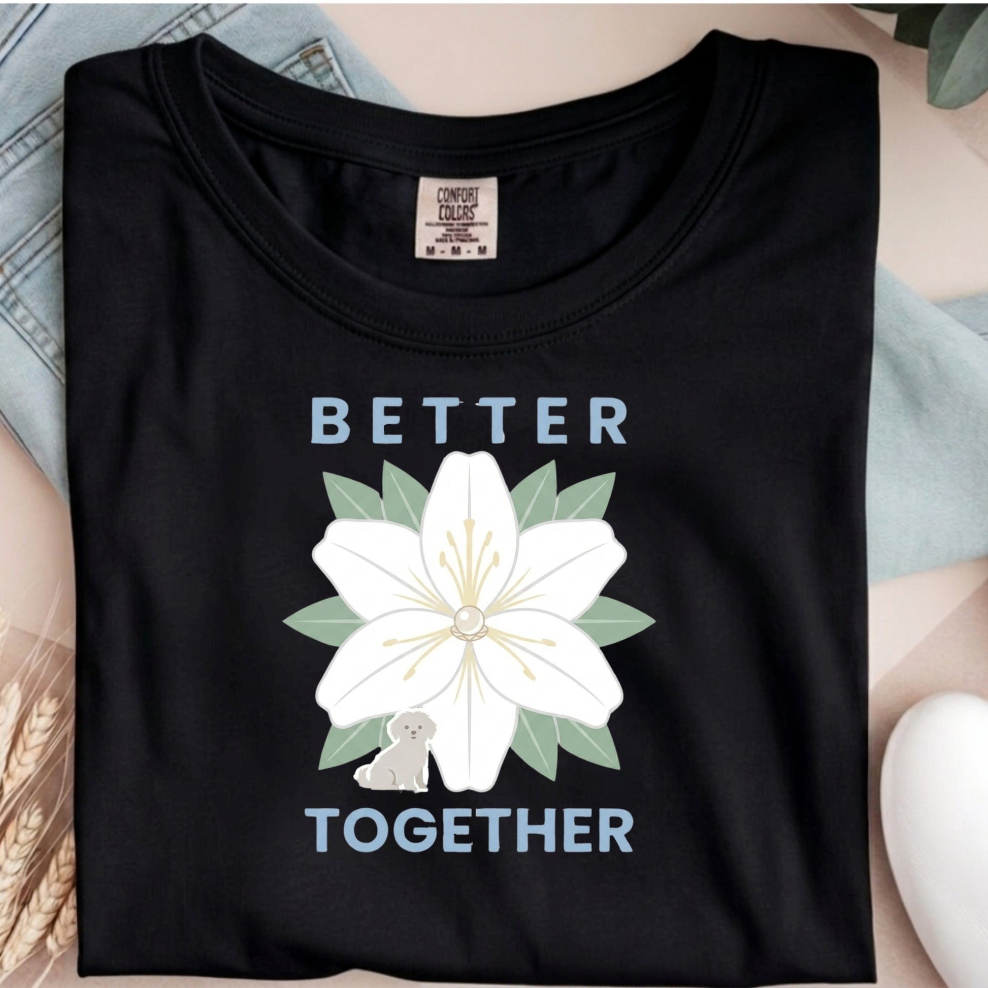 Black t-shirt with a white flower design and 'Better Together' text on a neutral background
