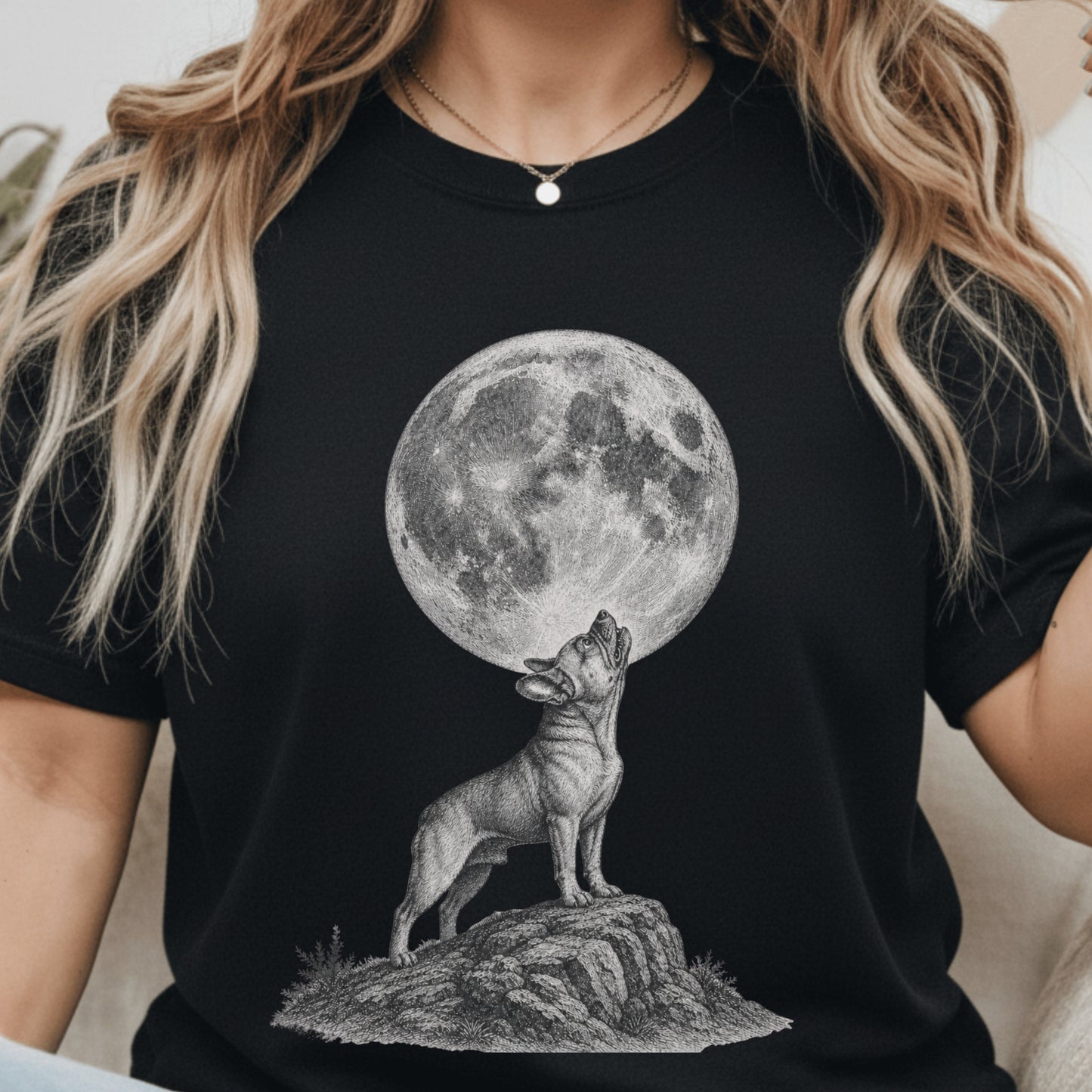 A woman wearing a black short-sleeve t-shirt with a detailed black and white graphic of a howling wolf beneath a large full moon.