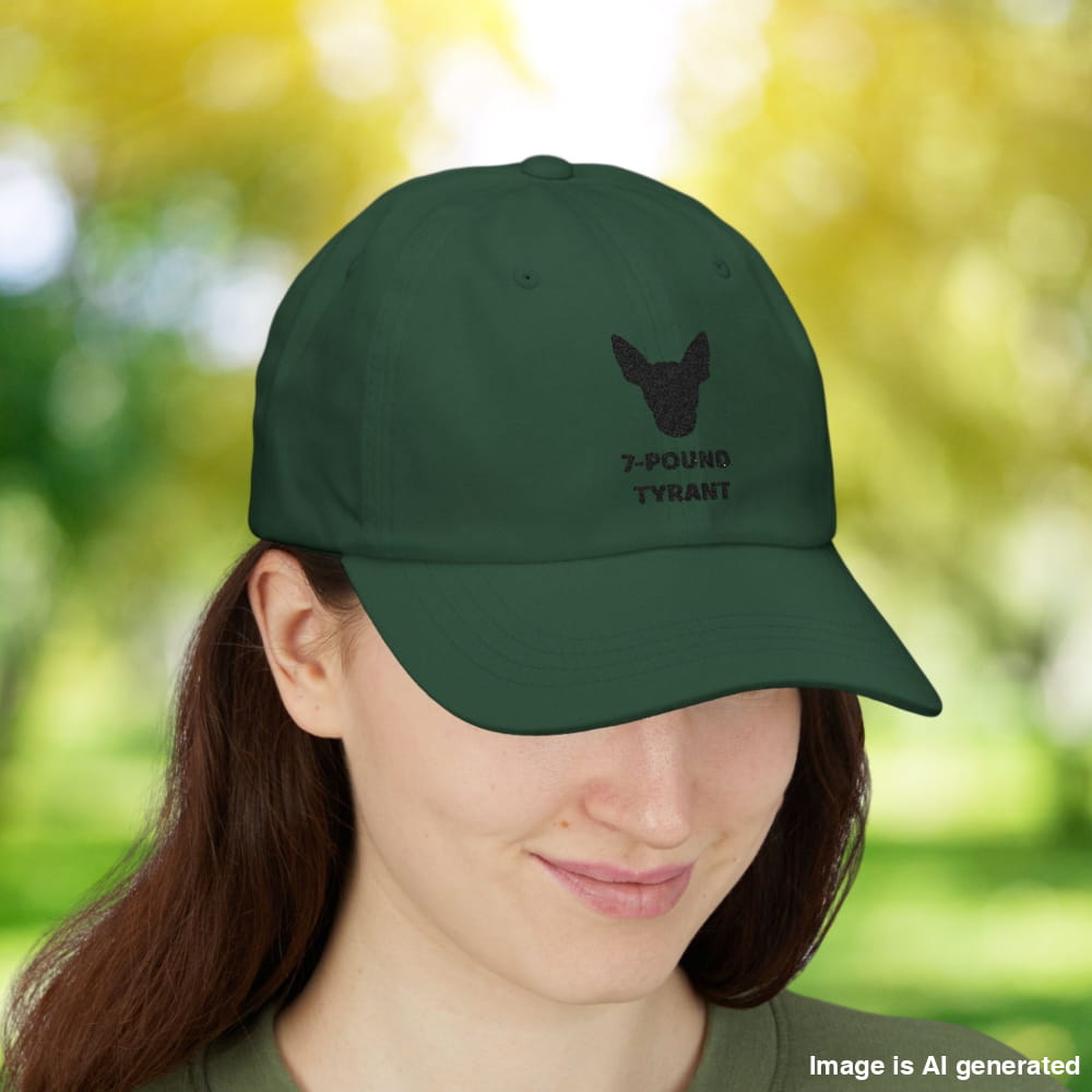 Spruce "7-Pound Tyrant" Miniature Pinscher cap with black dog silhouette embroidery, worn by a woman.