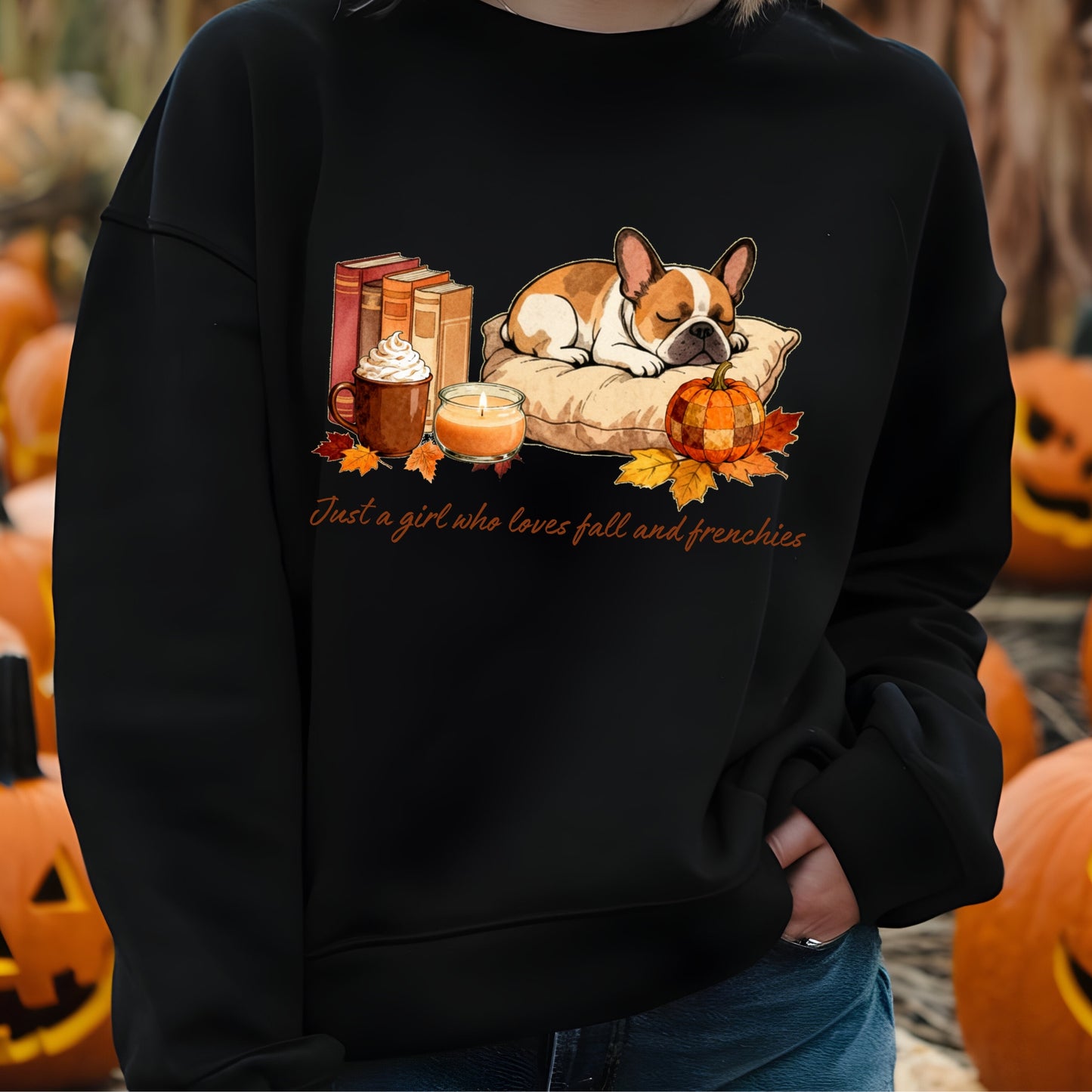 Black sweatshirt with a dog and fall-themed design, worn by a person in front of pumpkins.