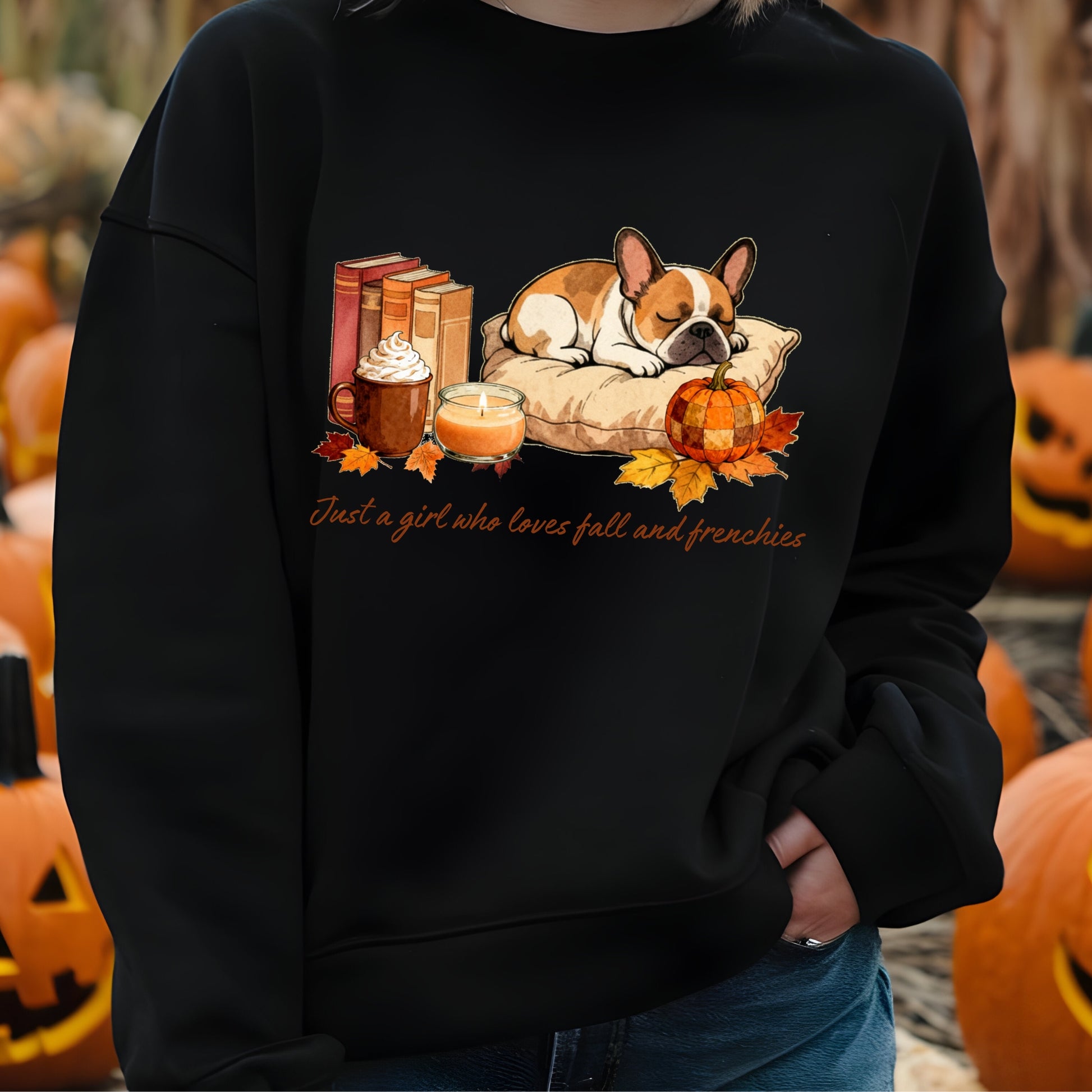 Black sweatshirt with a dog and fall-themed design, worn by a person in front of pumpkins.