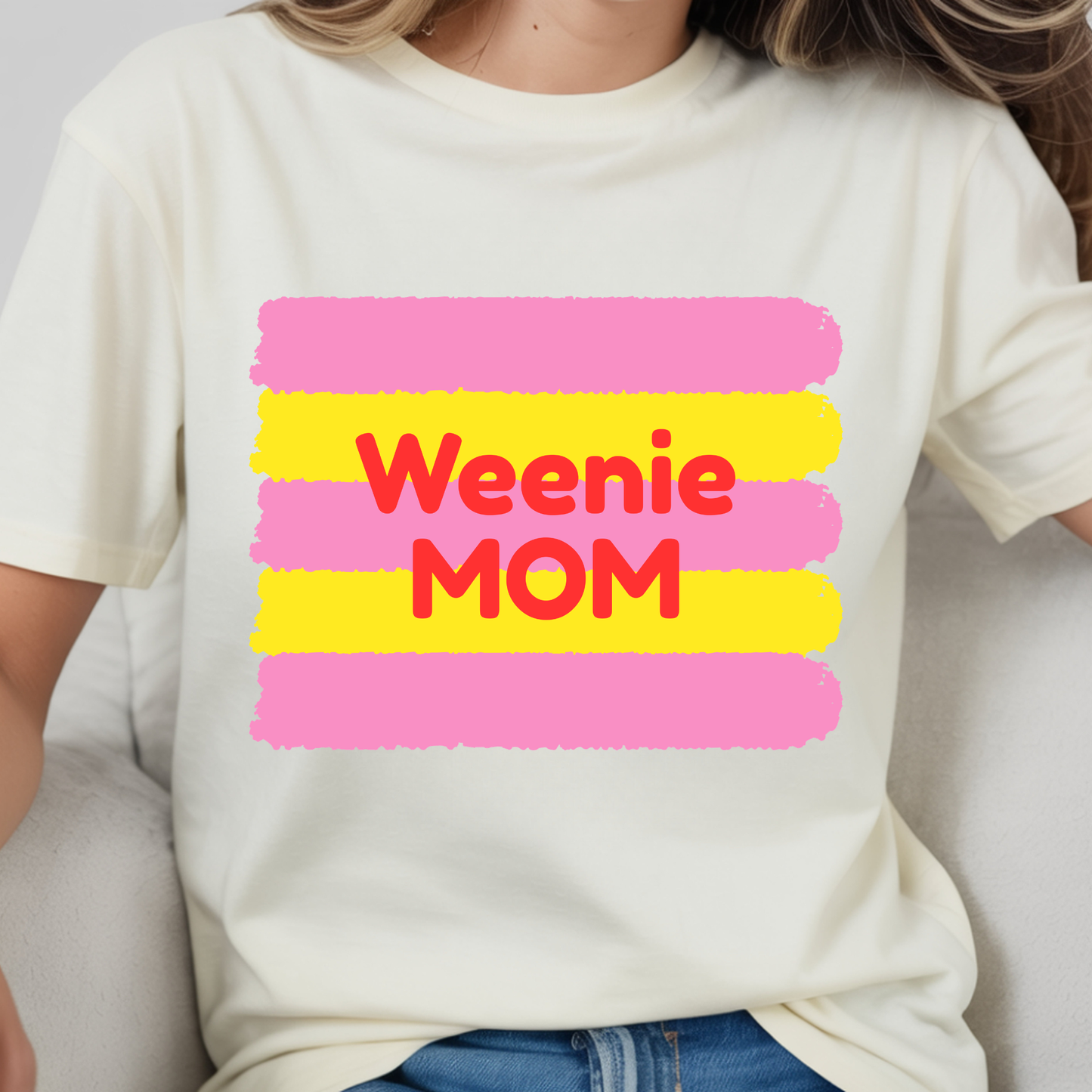 White t-shirt with 'Weenie Mom' text in red and pink on a white background