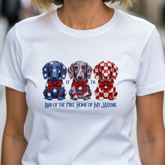 White t-shirt with colorful dog illustrations and text on a blurred background