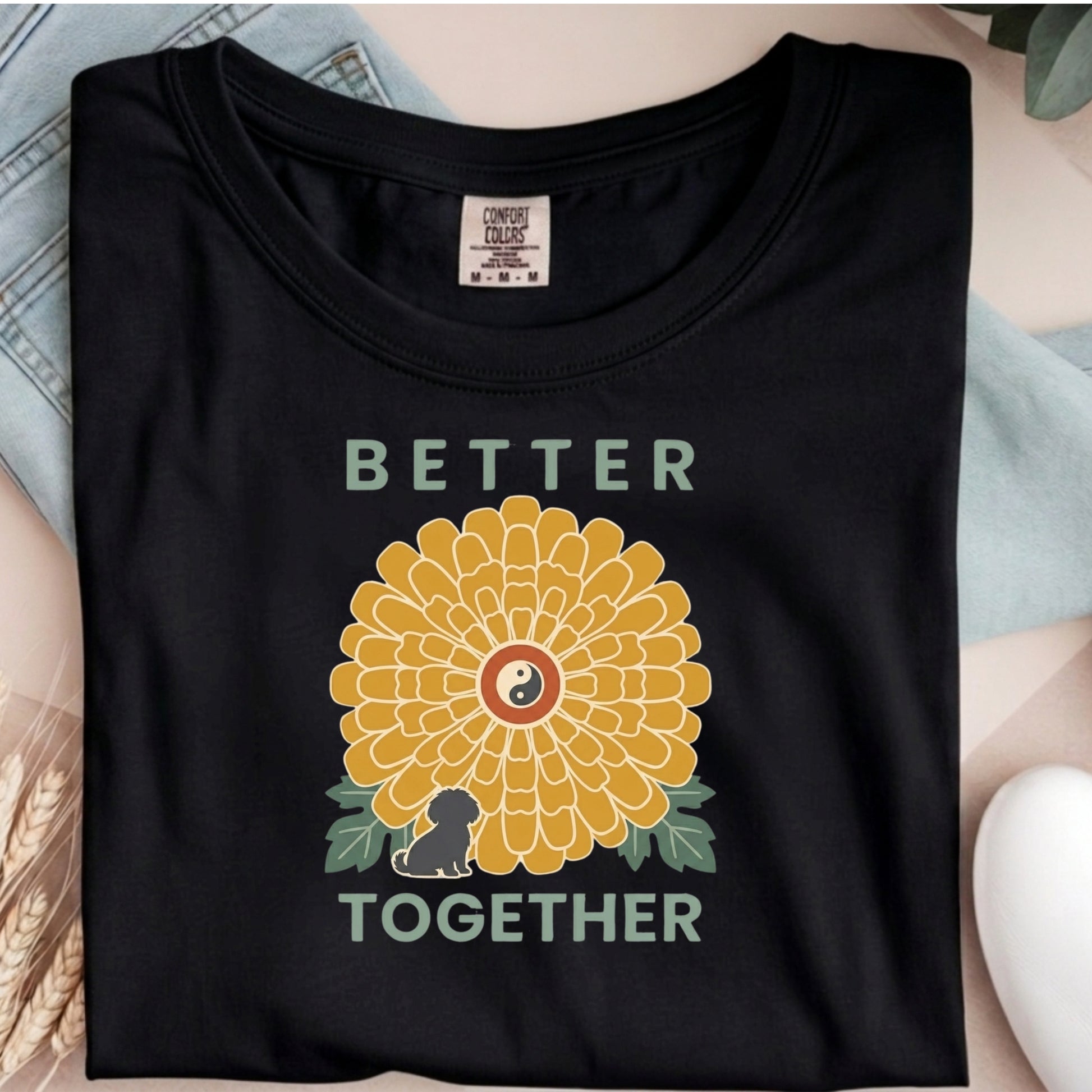 Black t-shirt with a yellow flower graphic and 'Better Together' text on a neutral background