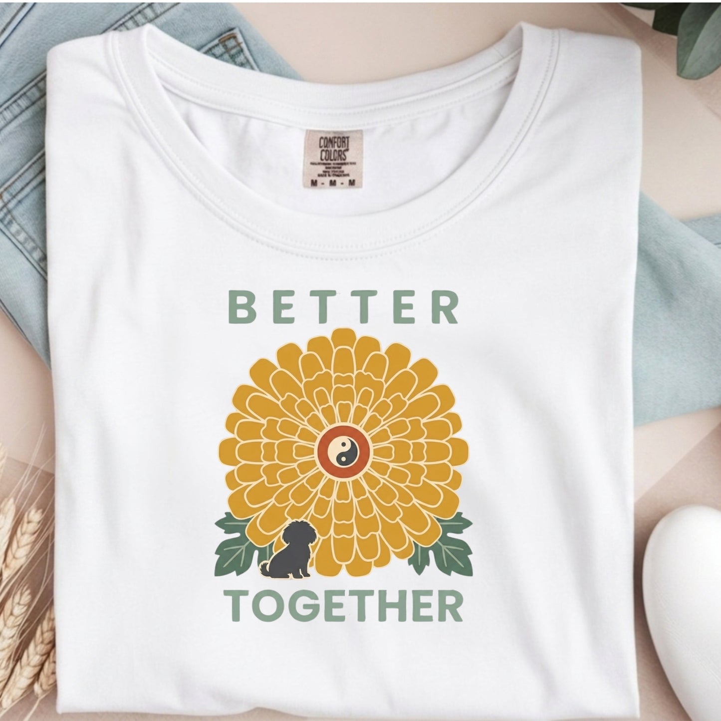 White t-shirt with a sunflower design and 'Better Together' text on a neutral background