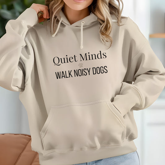 Woman wearing beige hoodie with “Quiet Minds Walk Noisy Dogs” text, perfect for dog lovers and walkers