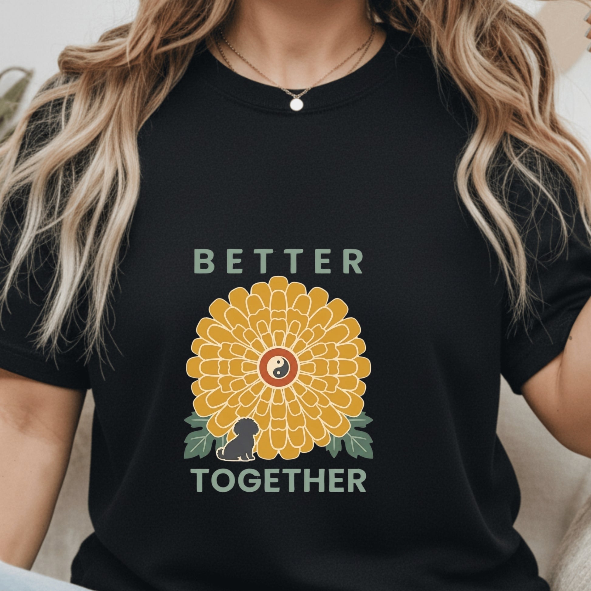 Black t-shirt with a yellow flower graphic and 'Better Together' text worn by a person.