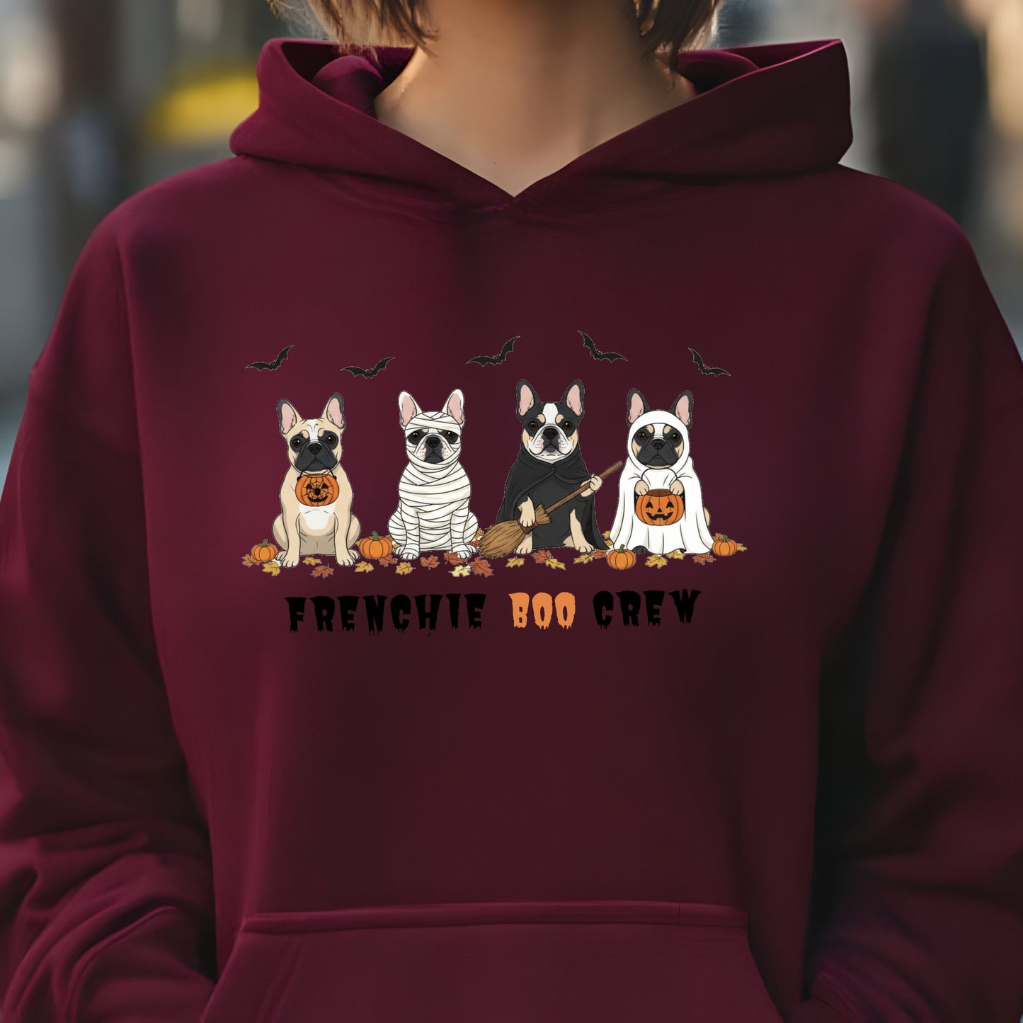 Halloween hoodie with four cartoon French Bulldogs in costumes, bats and pumpkins, and “Frenchie Boo Crew” text on white fabric.