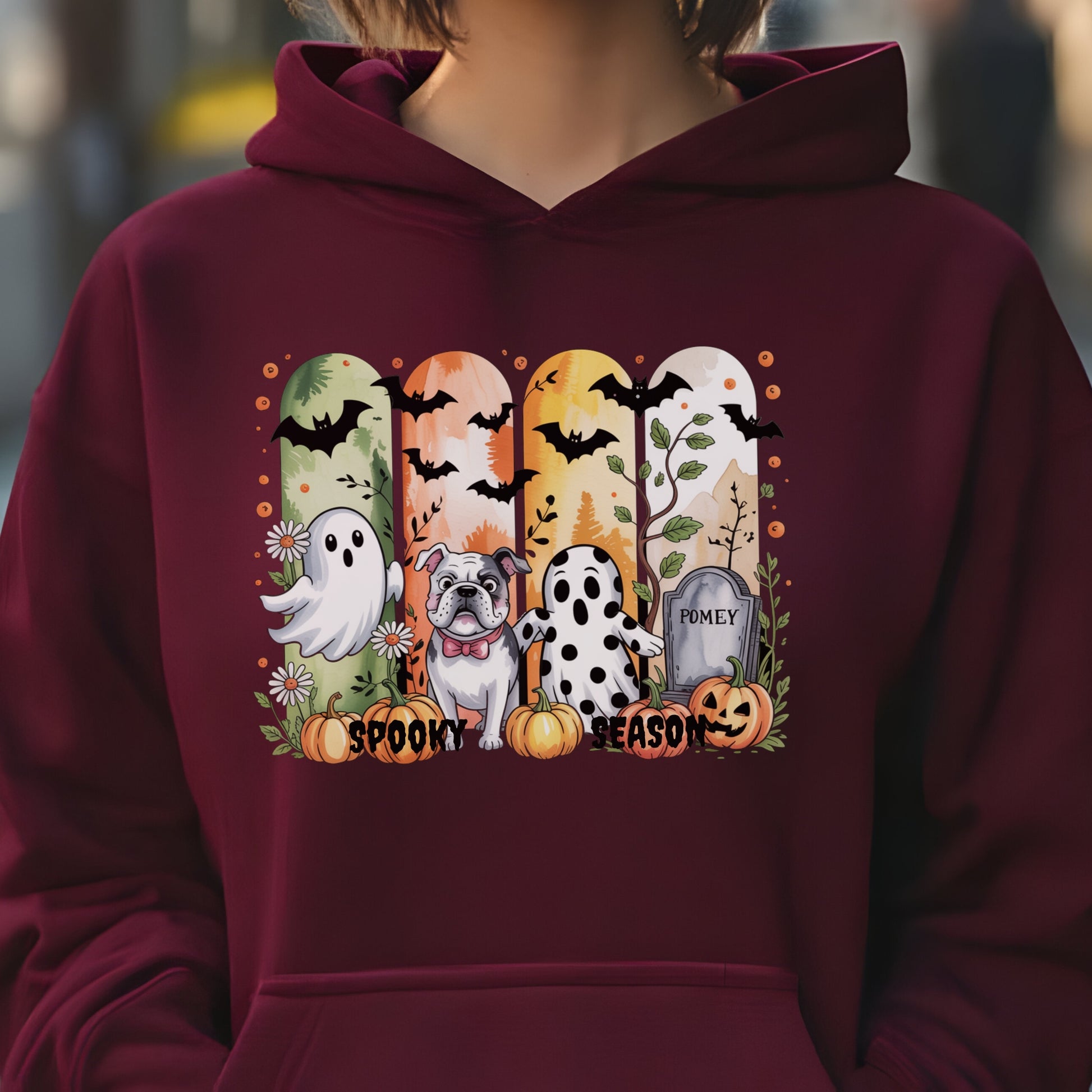 Maroon hoodie with Halloween-themed print of small dogs in ghost costumes, bats, pumpkins, and “Spooky Season” text on the front.