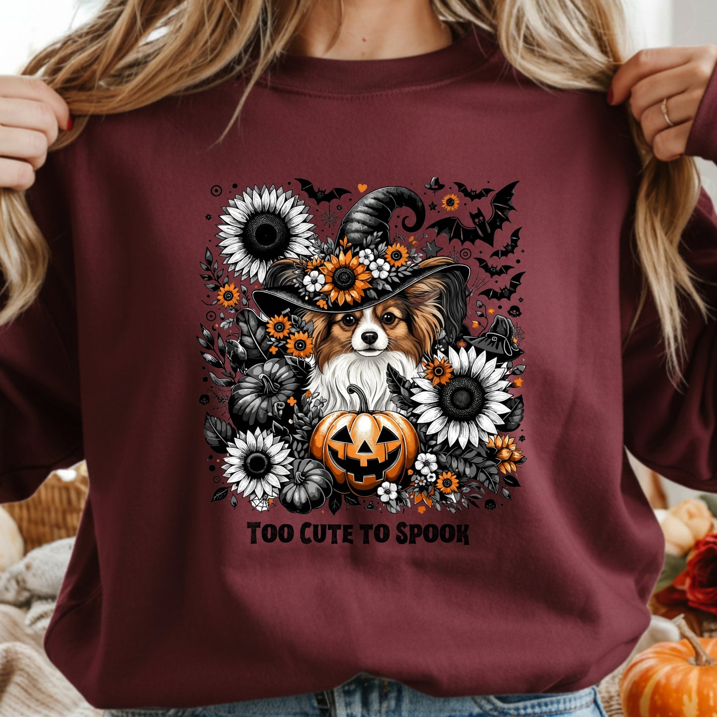 Maroon sweatshirt with a Halloween-themed design featuring a dog, pumpkin, and flowers.