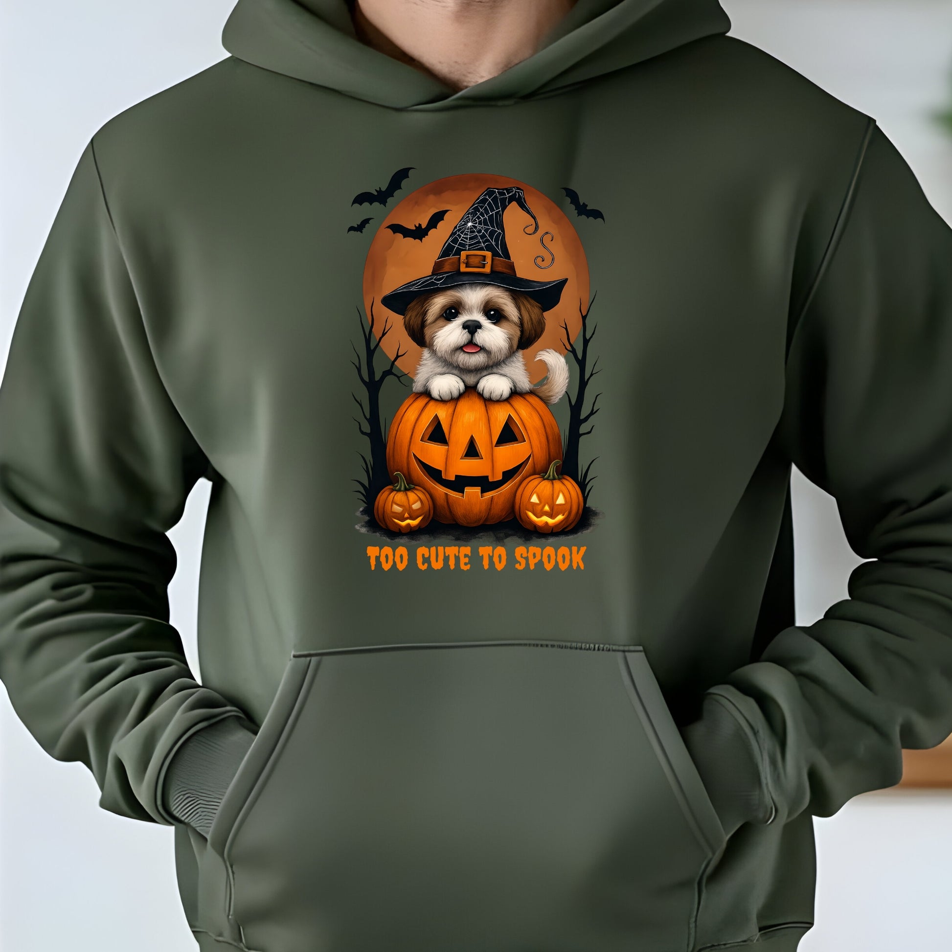 Green hoodie with a Halloween-themed design featuring a dog in a pumpkin and text 'Too Cute to Spook'.