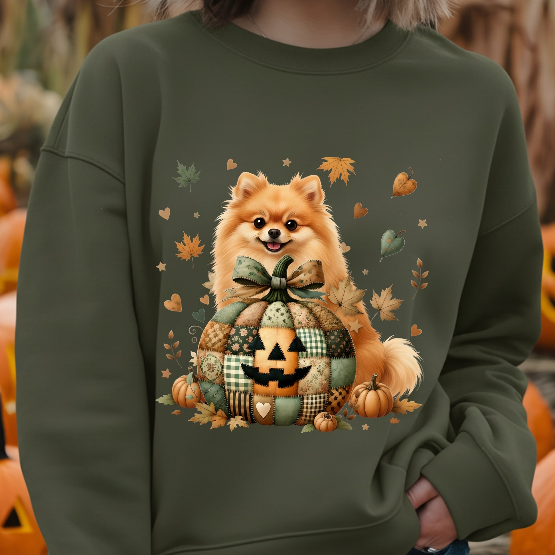 Green sweatshirt with a dog and Halloween-themed design, worn by a person.